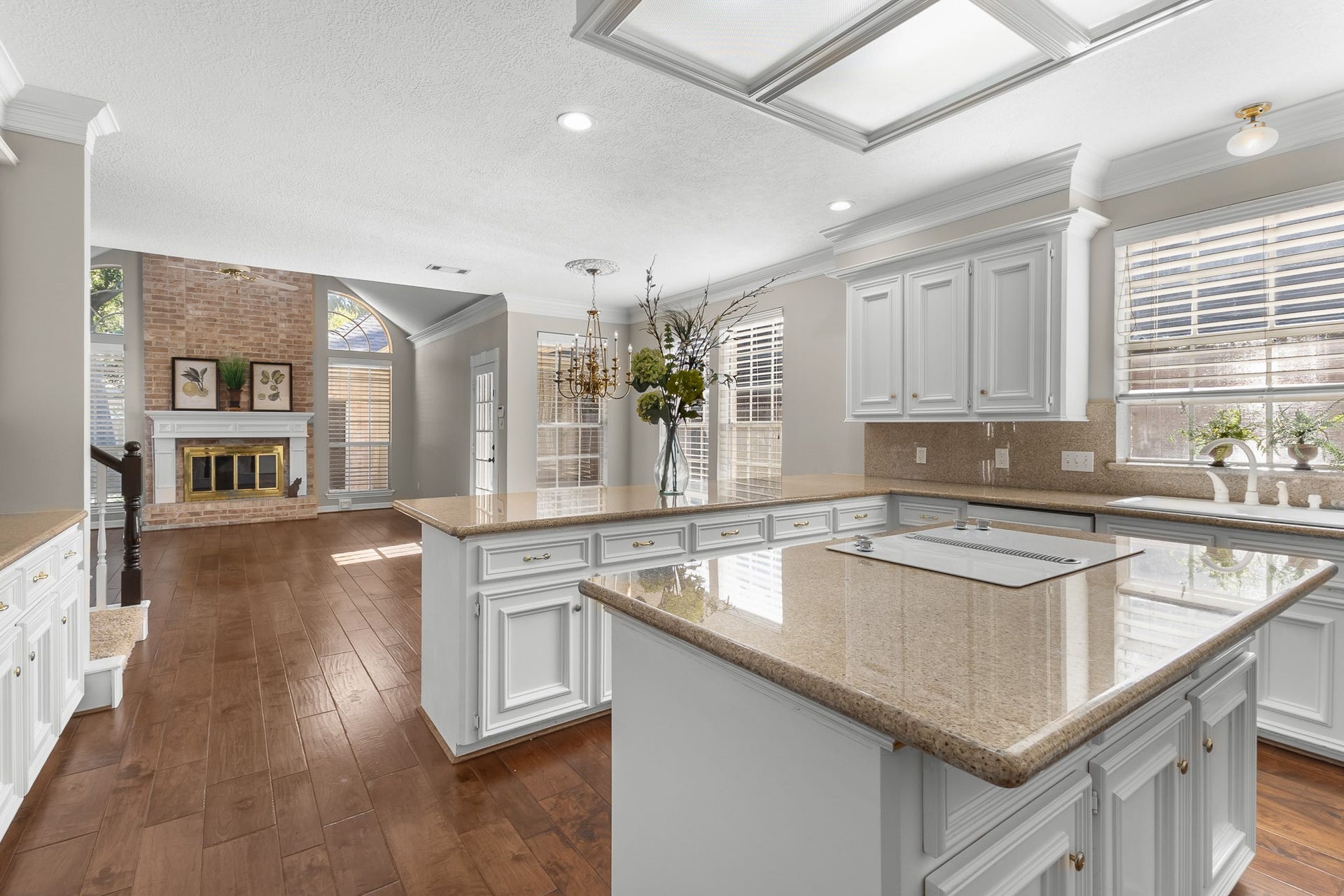 16314 Graven Hill Drive, Spring, TX 77379 The expansive kitchen opens toward the family room, creating an inviting flow between meal preparation and everyday gathering spaces.