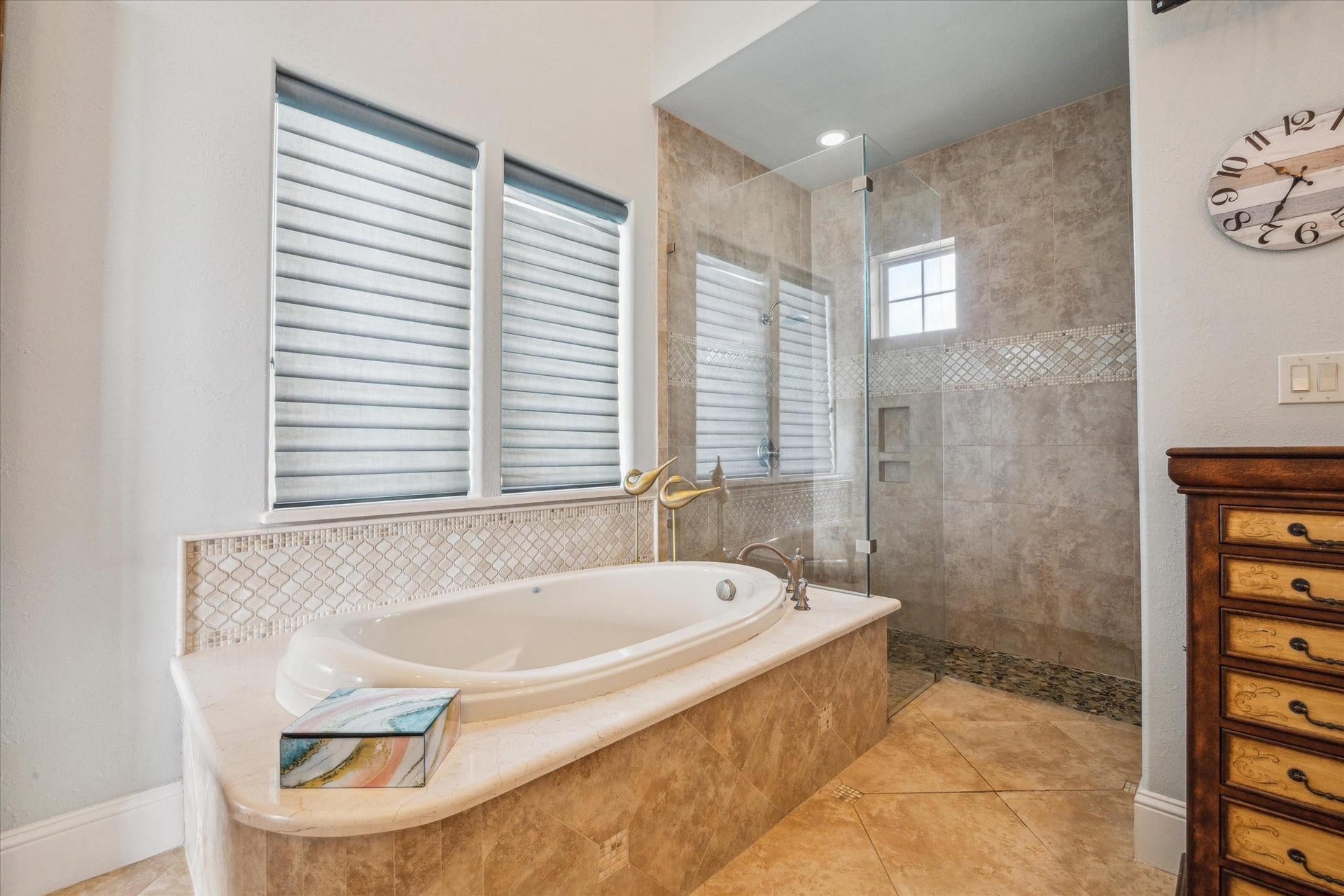 9 Happy Jack, Hitchcock, TX 77563 The spa-like ambiance continues in the primary bath with a large soaking tub, and a walk-in frameless glass showerall designed to elevate everyday comfort with timeless elegance. The expansive primary closet offers built-ins and is very spacious