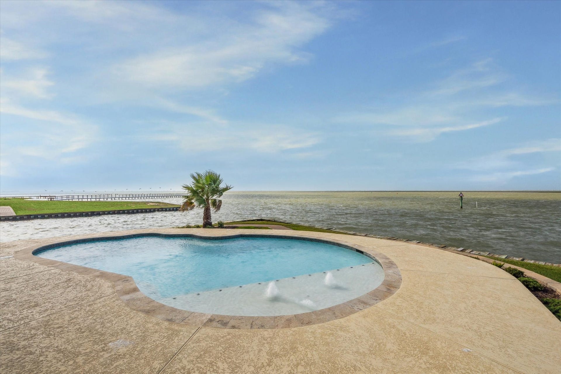 9 Happy Jack, Hitchcock, TX 77563 10,200-gallon capacity swimming pool overlooking West Galveston
Bay, including tanning ledge and side wall seating benches throughout,
with all pool equipment raised 5 feet on stilt platform. Bayfront views from the left angle of the pool area