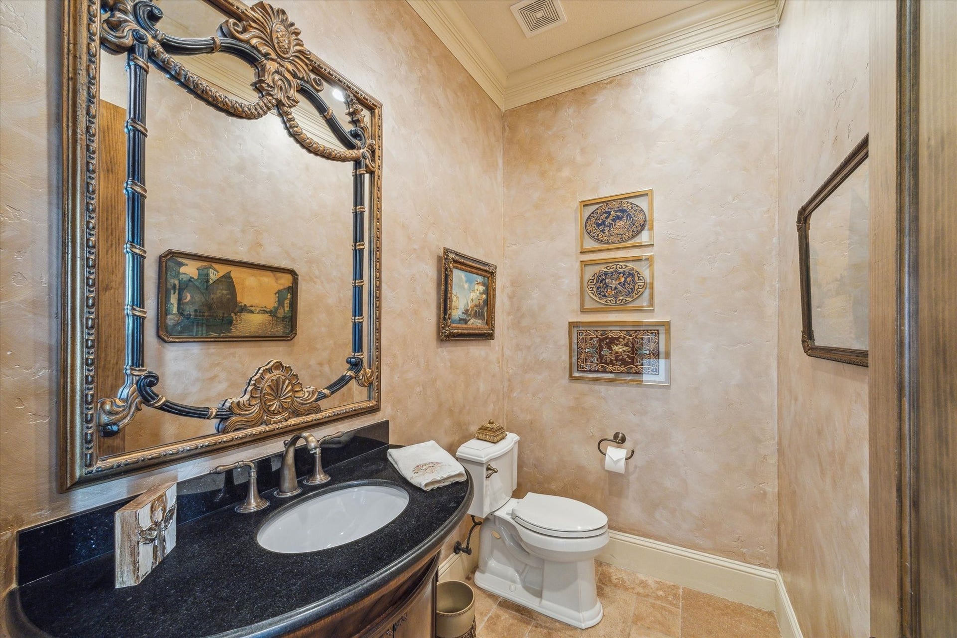 9 Happy Jack, Hitchcock, TX 77563 The powder room offers added convenience for guests, featuring rich textured walls, elegant crown molding, and a granite-topped vanity with warm wood cabinetry. A decorative framed mirror and ambient lighting completing the space