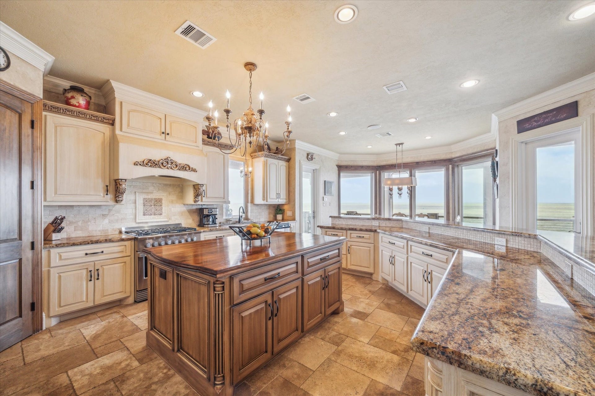 9 Happy Jack, Hitchcock, TX 77563 This extraordinary chefs kitchen is a showpiece of Mediterranean-inspired design and high-end functionality, perfectly paired with breathtaking panoramic bay views. At its center, a grand solid wood stained island
