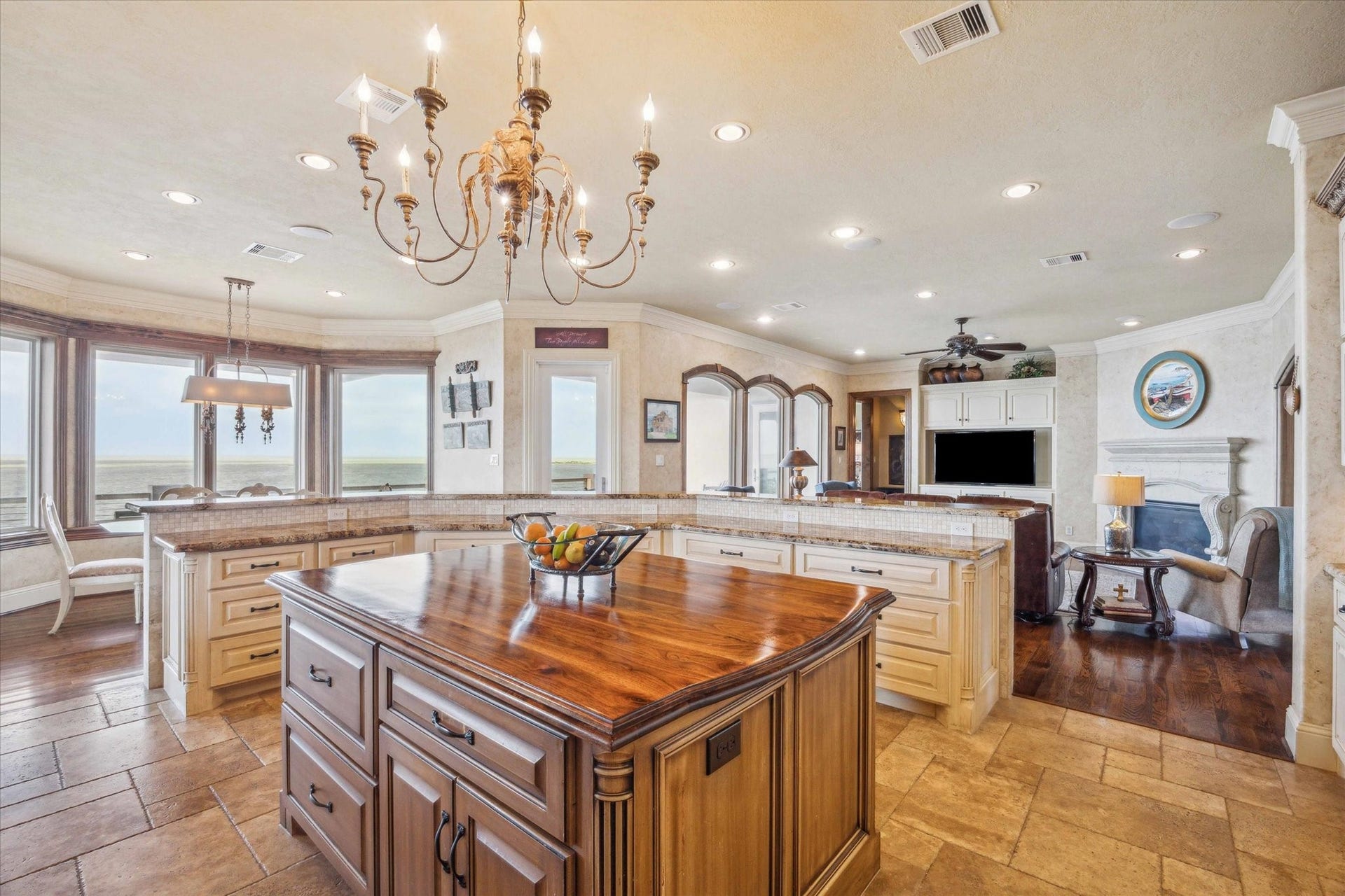 9 Happy Jack, Hitchcock, TX 77563 From this impeccably designed kitchenfeaturing custom cabinetry, granite countertops, and designer lightingenjoy an effortless flow into the refined living and dining spaces, all framed by a wall of windows showcasing unobstructed, panoramic views of West Galveston Bay