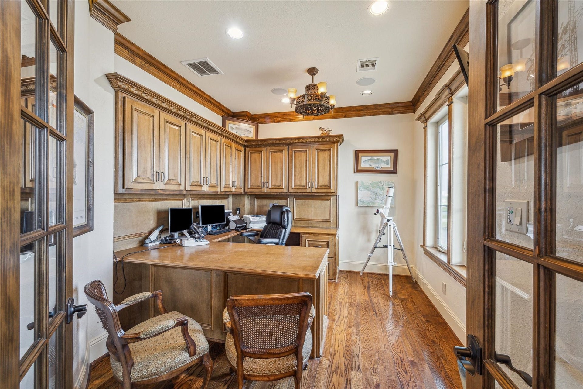 9 Happy Jack, Hitchcock, TX 77563 A dedicated home office or study features double entry doors, rich stained cabinetry, a built-in desk, and ample storageoffering both functionality and sophistication in a private workspace
