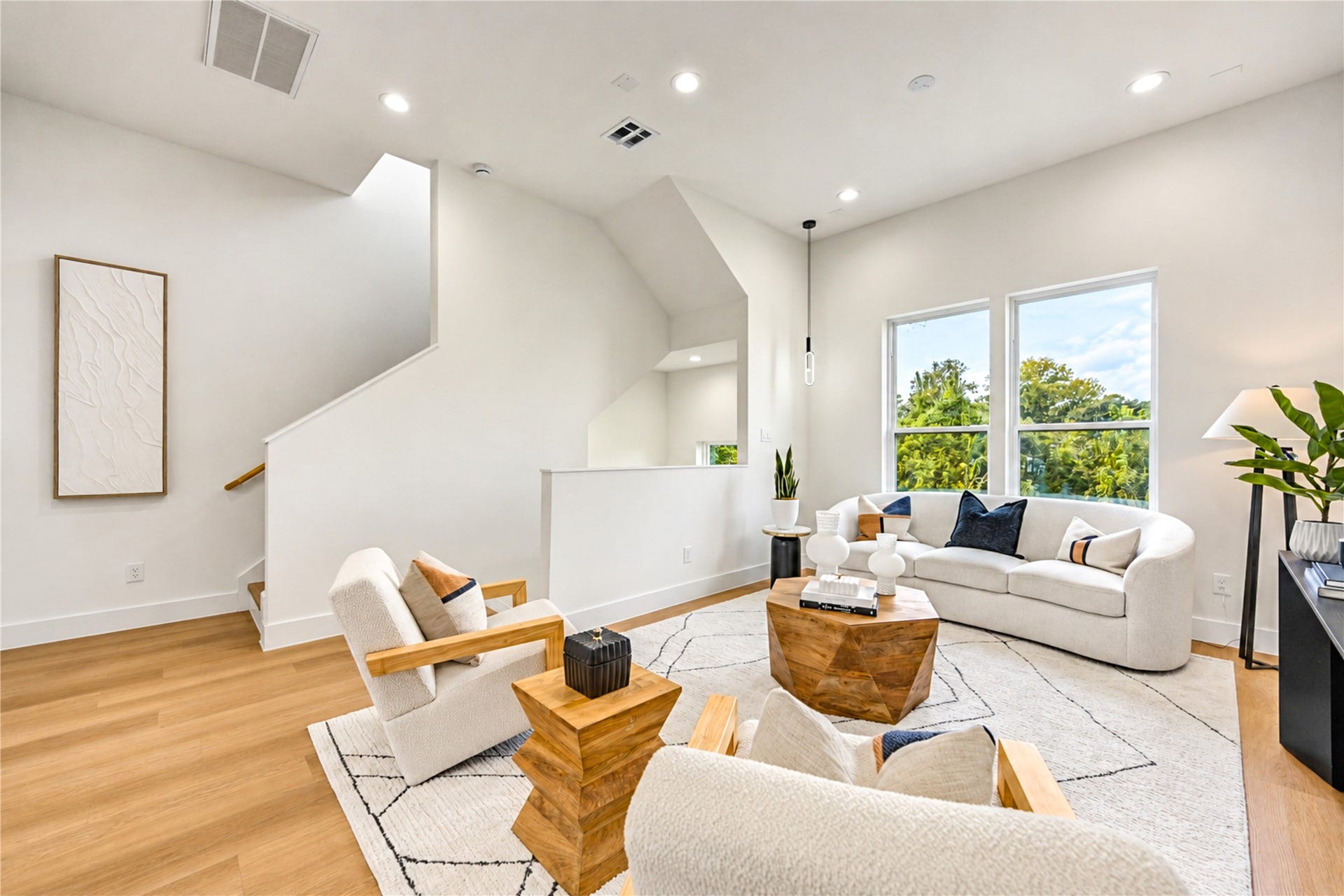 Inviting living room with large windows and abundant natural light, perfect for entertaining.