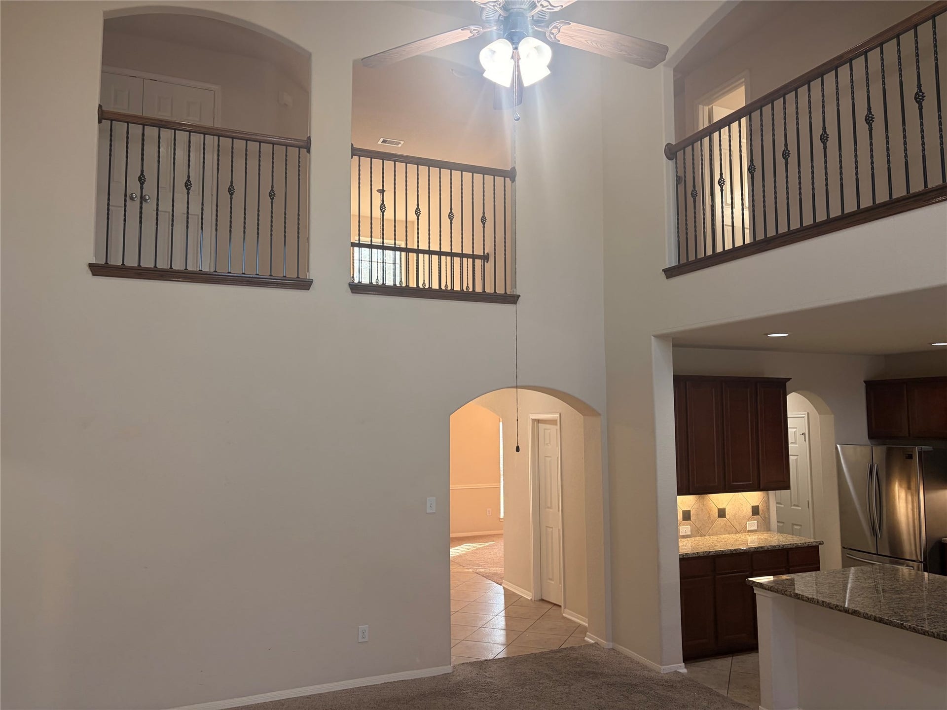 1230 Martinez Court, Friendswood, TX 77546 View of the beautifully handcrafted white iron railings, looking up towards the game room.