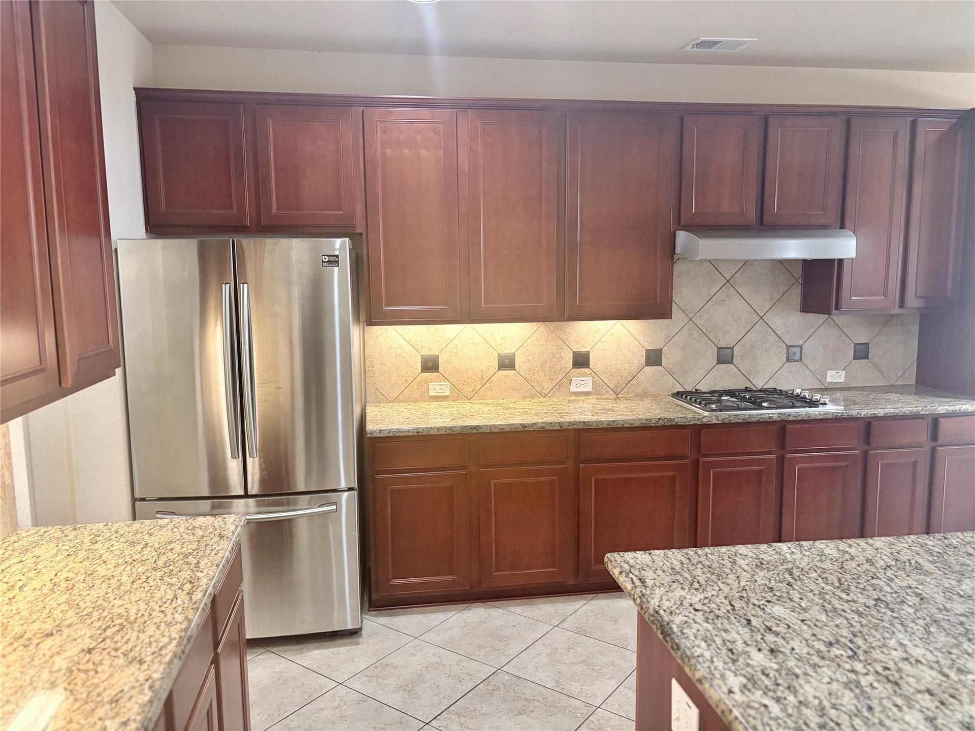 1230 Martinez Court, Friendswood, TX 77546 Ceramic tile backsplash with diamond accent, and 42 inch cabinets