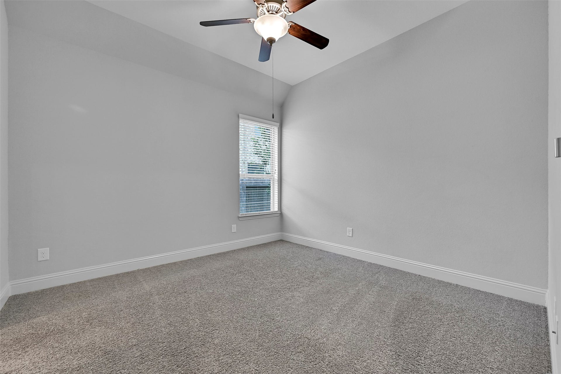 1321 Summer Field Lane, Friendswood, TX 77546 This spacious secondary bedroom features plush carpet, a ceiling fan, large window with backyard views, and a neutral color palette ready for any dcor style. Conveniently located on the first floor, it offers comfort and privacy for family members or overnight guests.