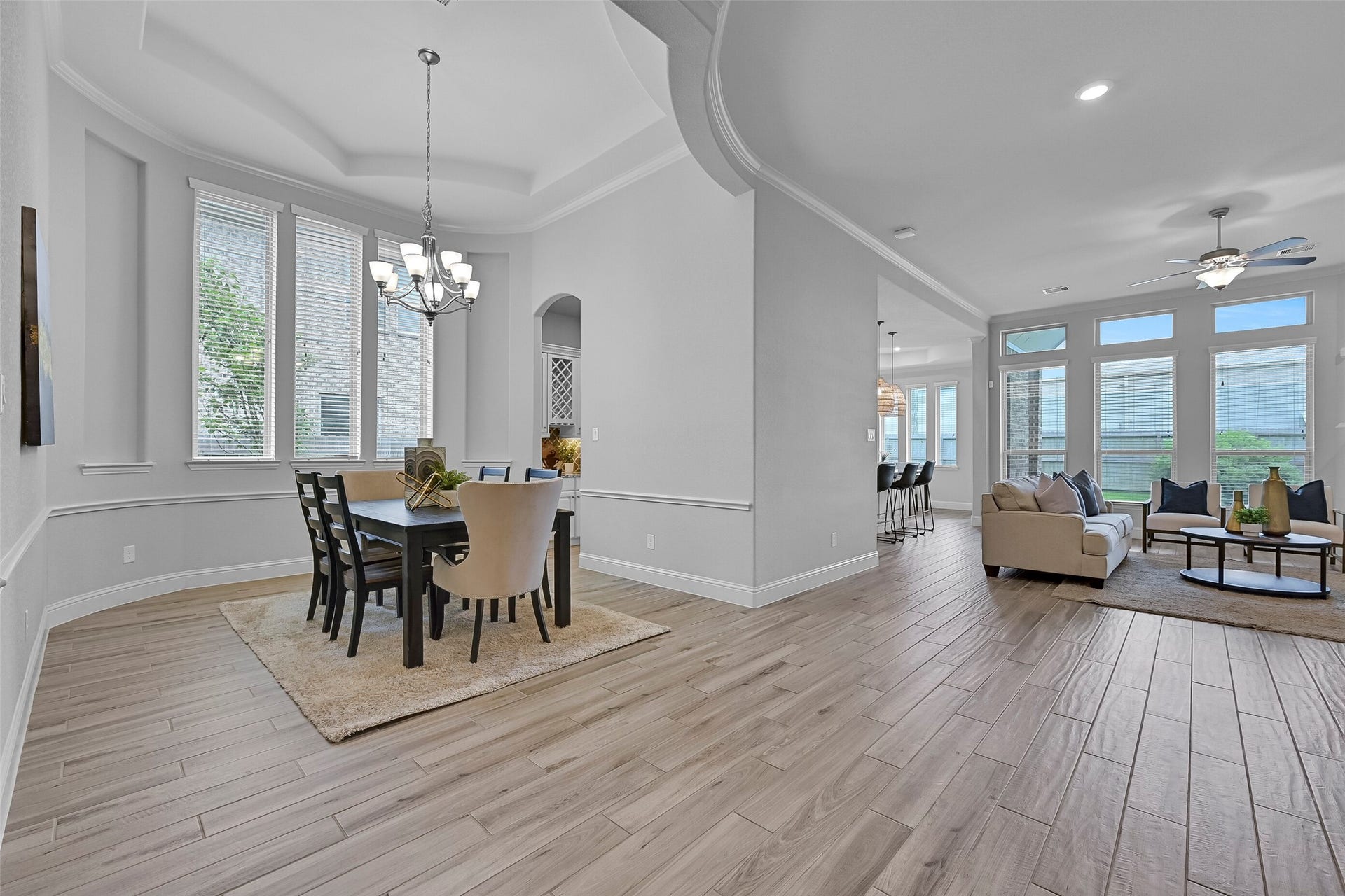 1321 Summer Field Lane, Friendswood, TX 77546 Looking beyond the dining room, you'll appreciate the openness of this Village Builders design. Wood-look tile flooring flows throughout the main living areas while walls of windows, soaring ceilings, and thoughtfully designed gathering spaces create a bright and connected feel throughout the first floor.
