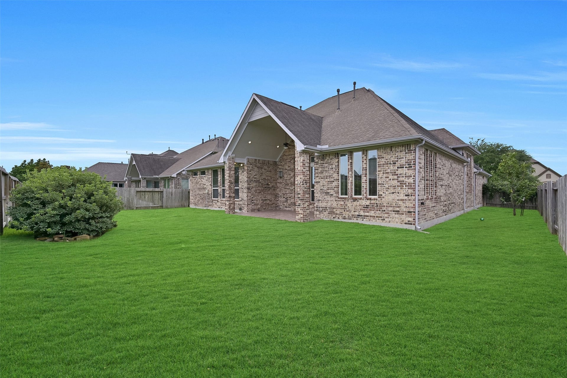 1321 Summer Field Lane, Friendswood, TX 77546 The oversized backyard offers endless possibilities, whether you envision a future pool, play space, garden, or outdoor entertaining area. The extended rear elevation showcases the home's thoughtful design, while the covered patio creates a seamless connection between indoor and outdoor living. With no immediate rear neighbors and abundant green space, the setting feels both open and private.
