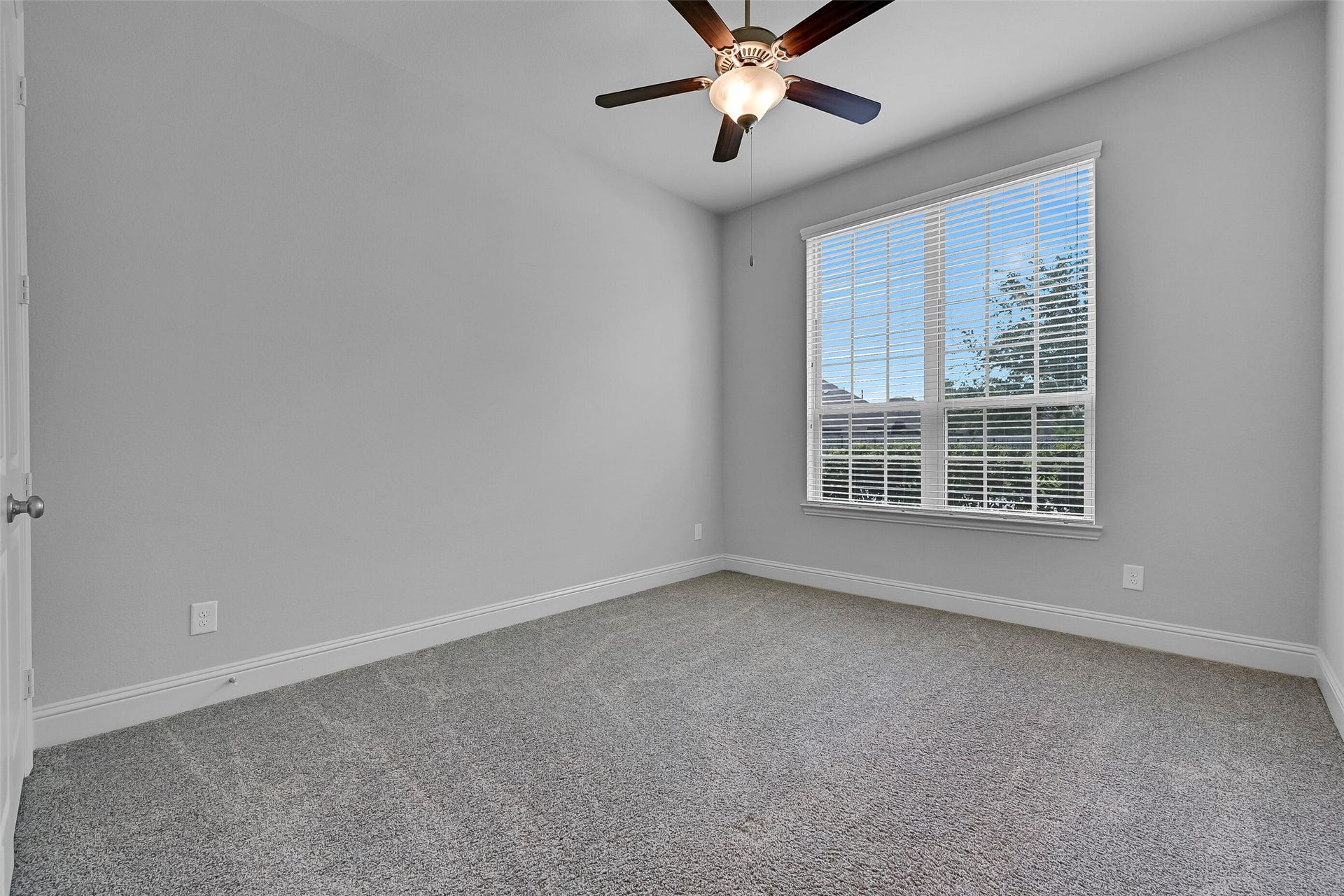 1321 Summer Field Lane, Friendswood, TX 77546 Privately situated near the front of the home, this secondary bedroom offers an ideal setup for guests, extended family, or a home office. Large windows provide natural light, while the neutral color palette, plush carpet, ceiling fan, and generous closet space create a comfortable retreat separated from the main living areas and primary suite.