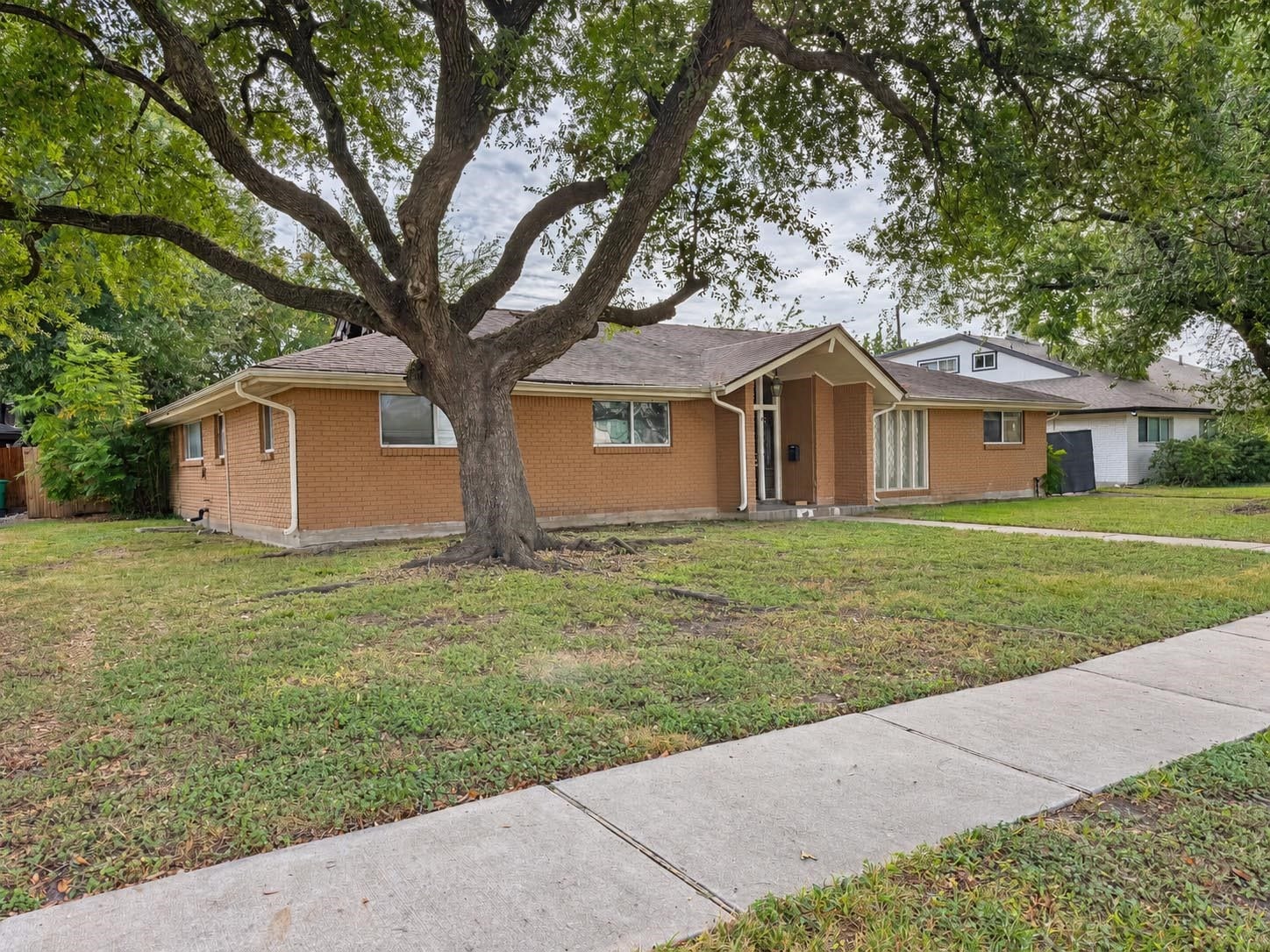 5111 Glenmeadow Drive, Houston, TX 77096 Subject property fire damaged house with large oak trees