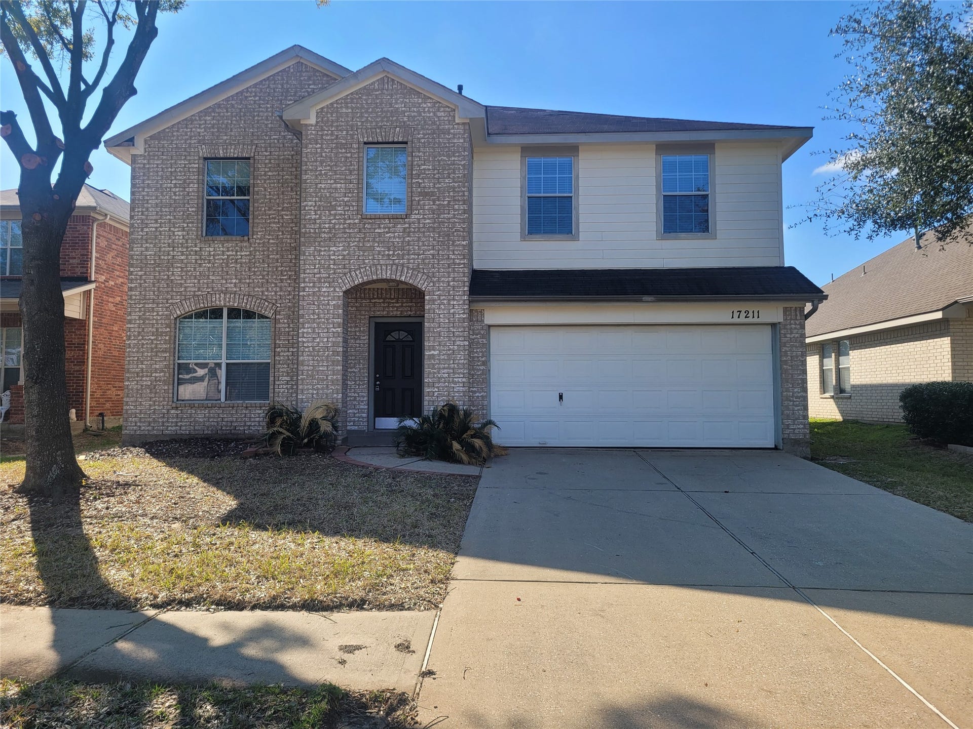 Charming two-story home with a welcoming faade, featuring a spacious driveway and a classic brick exterior. Ideal for modern living.
