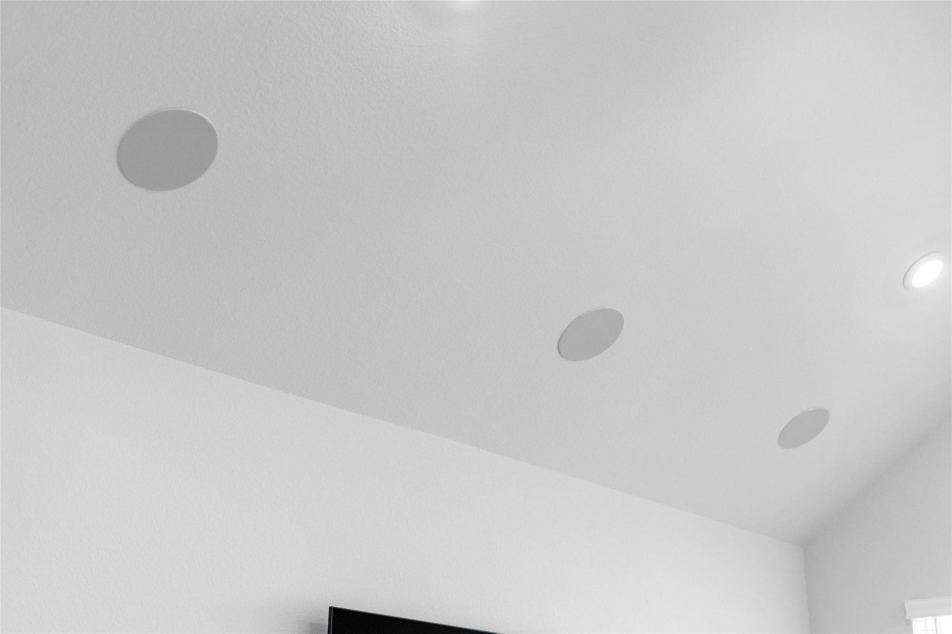 The home features premium integrated surround-sound ceiling speakers, delivering a sleek, low-profile media experience perfect for movie nights and seamless entertaining.