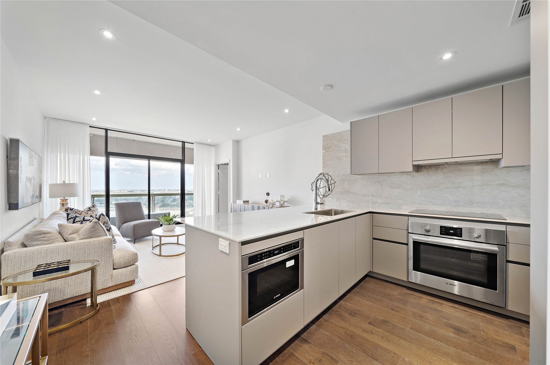 1701 Hermann Drive, #25A, Houston, TX 77004 High-end kitchen open to living area and bonus beautiful views. Color scheme in photo is from a similar unit.