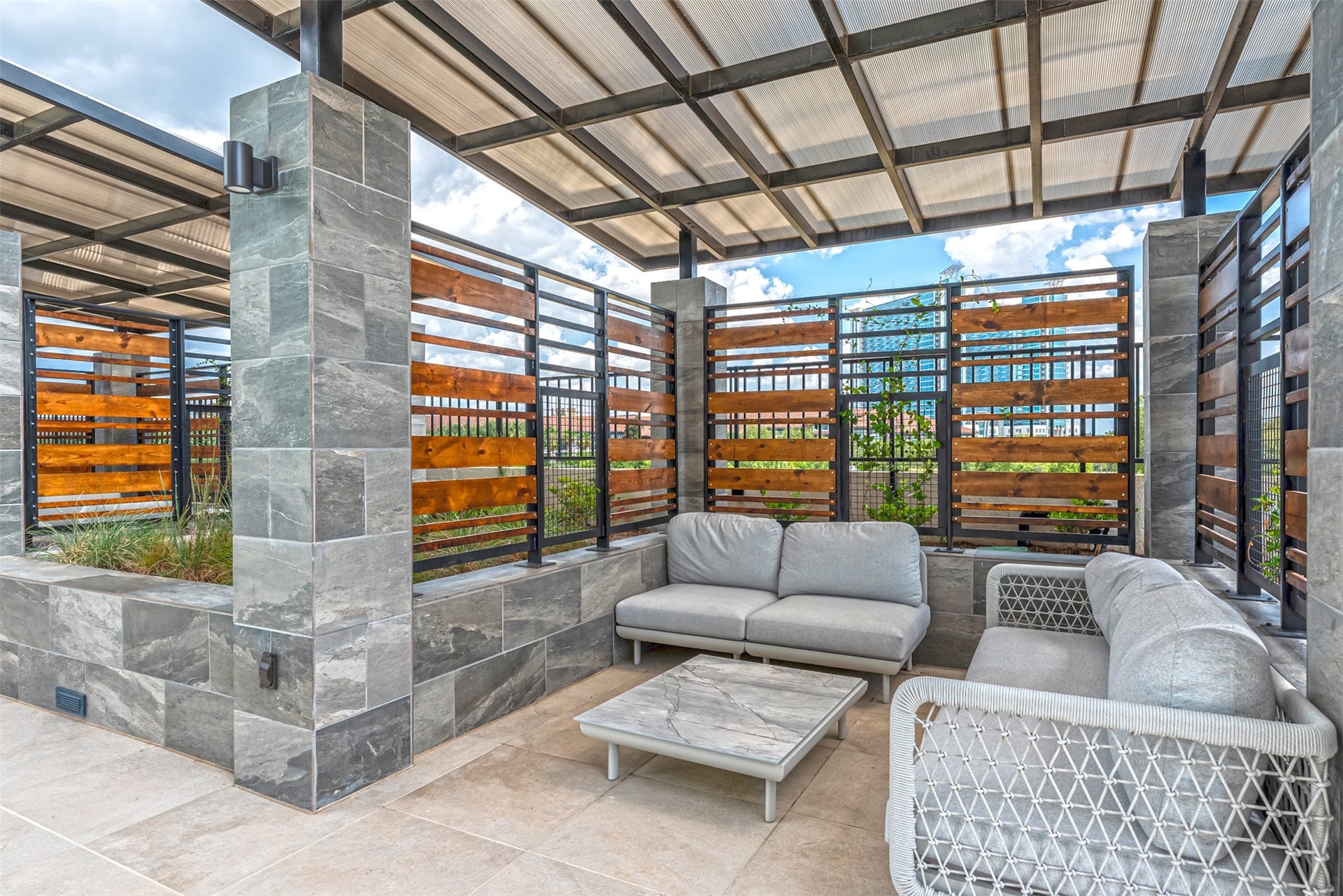 1701 Hermann Drive, #25A, Houston, TX 77004 Comfy couches and greenery make this a splendid space to spend an afternoon.