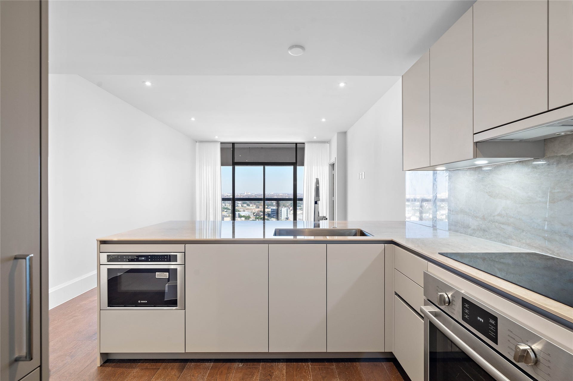 1701 Hermann Drive, #25A, Houston, TX 77004 Premium Bosch appliances including convection oven, induction cooktop drawer microwave, panelized dishwasher and refrigerator-freezer.
