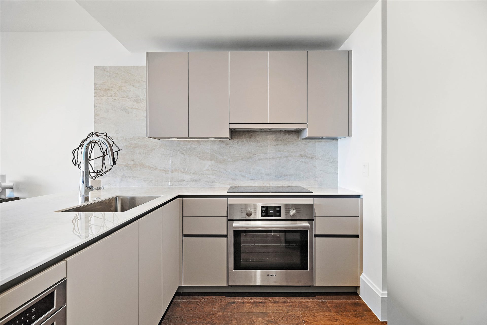 1701 Hermann Drive, #25A, Houston, TX 77004 Porcelain countertops and slab backsplash complement the rich cabinetry push-touch cabinetry.