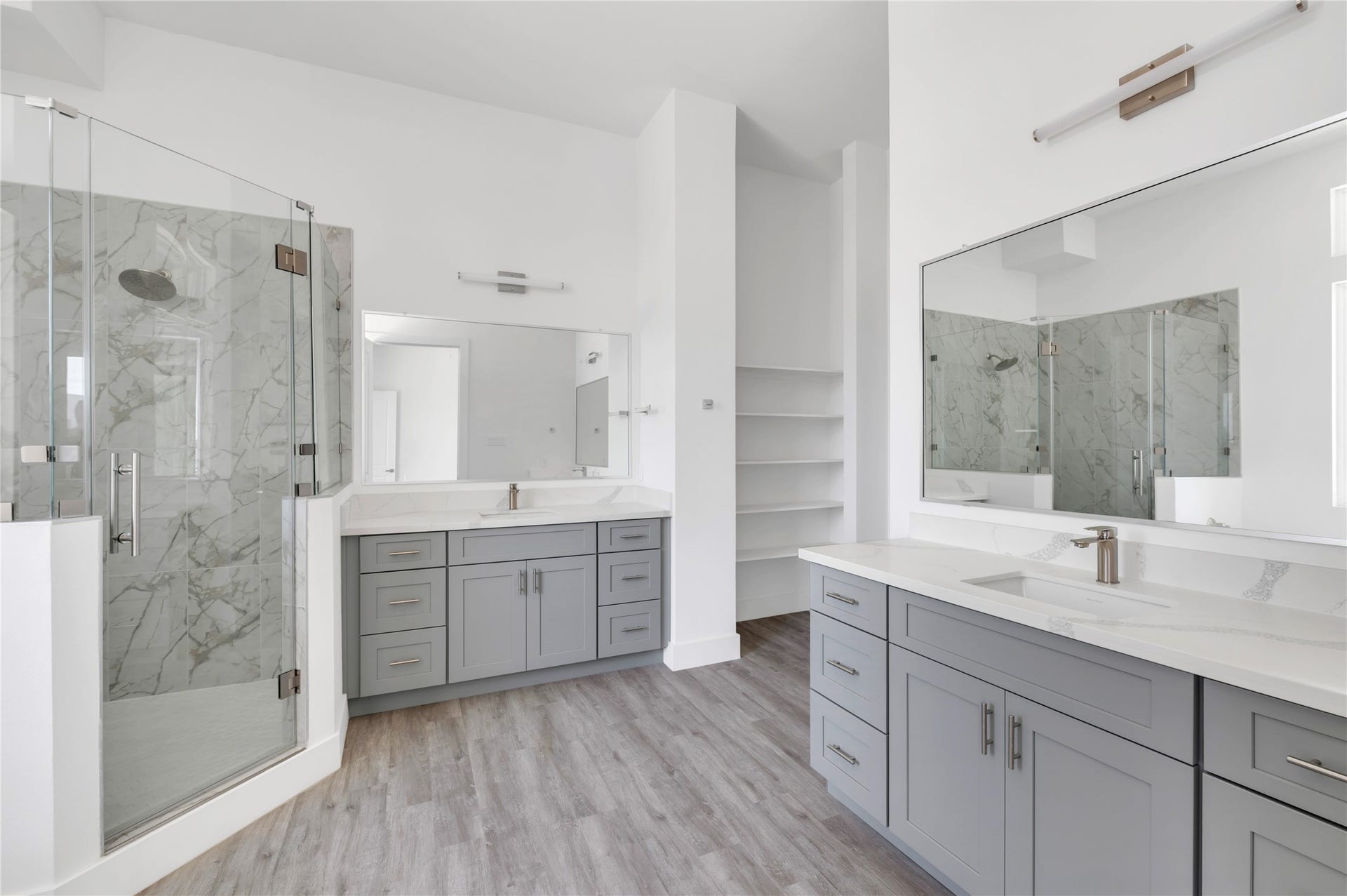 119 Kirby Road, #5304, Taylor Lake Village, TX 77586 Elegant bathroom featuring a spacious dual vanity with gray cabinetry, a large frameless glass shower with marble tile, and sleek modern fixtures.