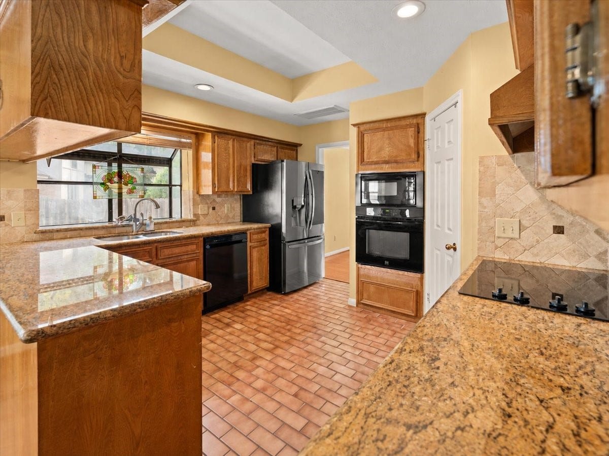 Enjoy a welcoming kitchen featuring beautiful granite countertops.