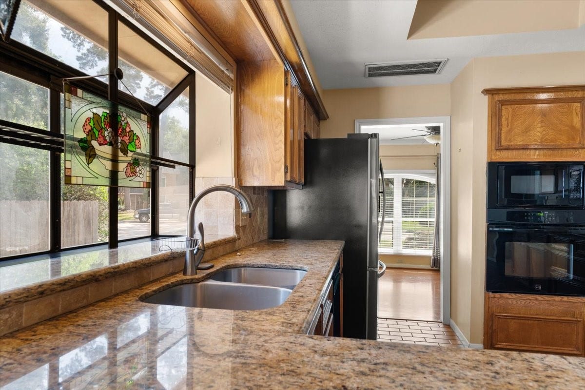 A large window above the kitchen sink brings in natural light and offers a lovely view while preparing meals or tackling everyday tasks.