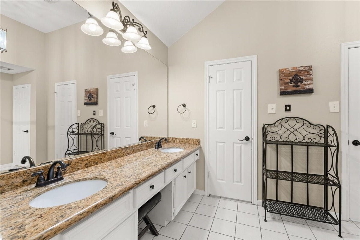 Primary bathroom with double sinks and granite counter tops