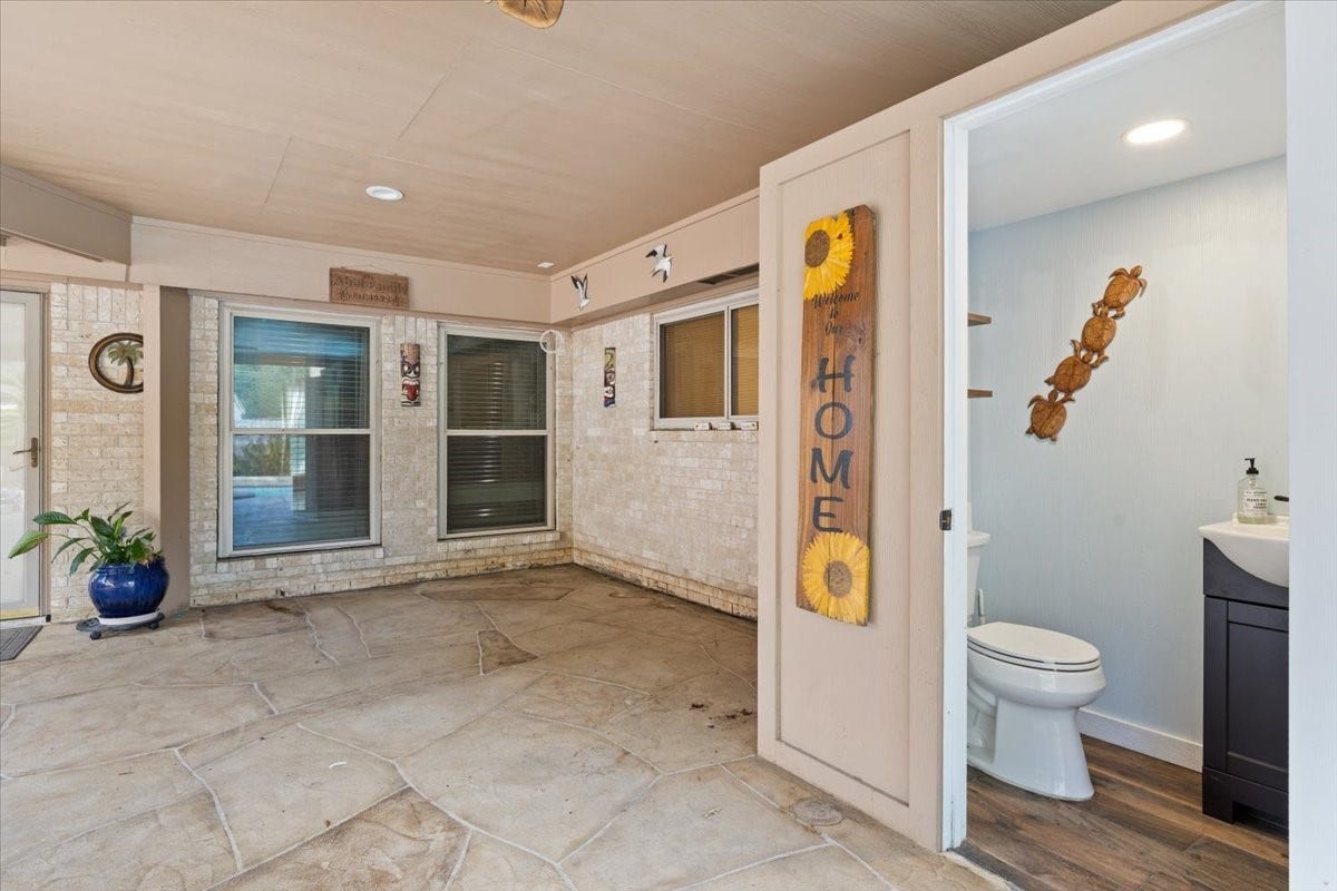 A dedicated outdoor restroom just off the patio adds comfort and convenience for pool days, backyard gatherings, and entertaining guests.