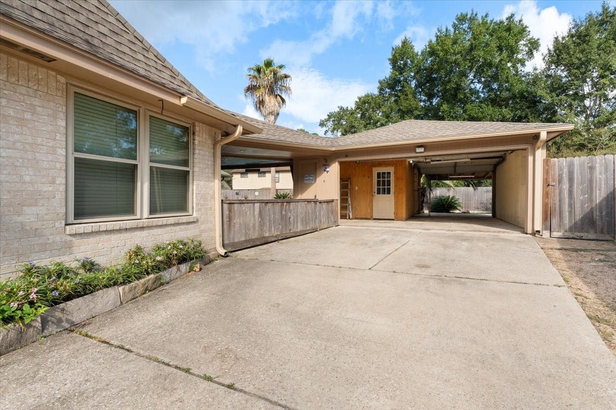 Long driveway and garage opens to back yard