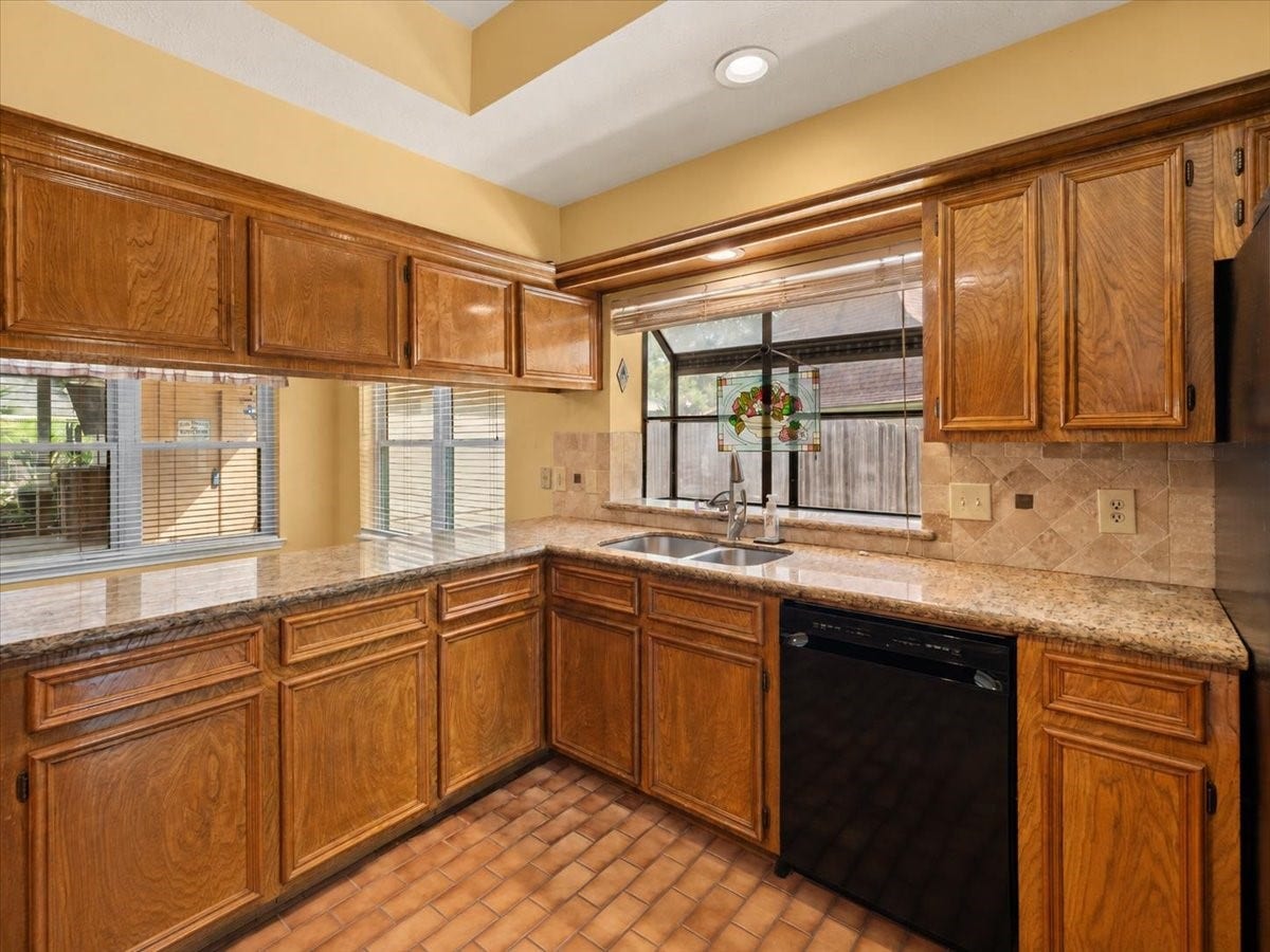Nice kitchen featuring beautiful granite countertops and a convenient breakfast bar.