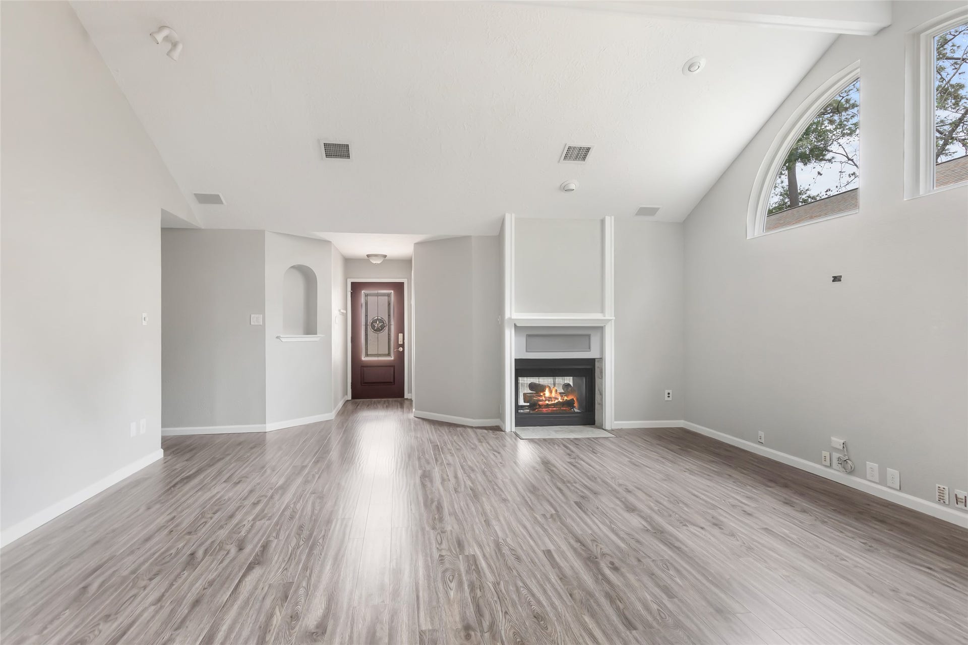 4210 Valley Glade Drive, Kingwood, TX 77345 Family room looking towards front door with shared fireplace