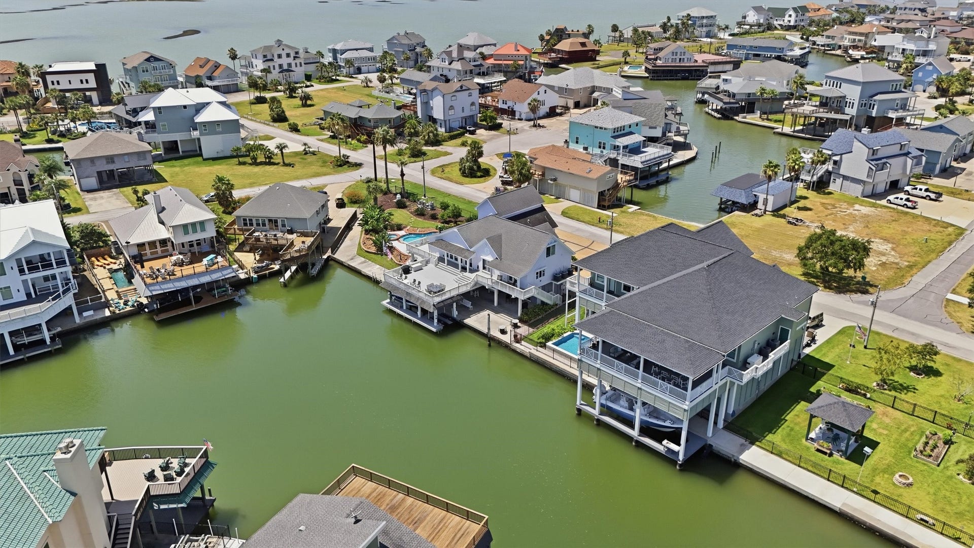 Surrounded by Tiki Islands waterways, this view highlights the homes direct canal access and easy connection to the boating lifestyle the community is known for.