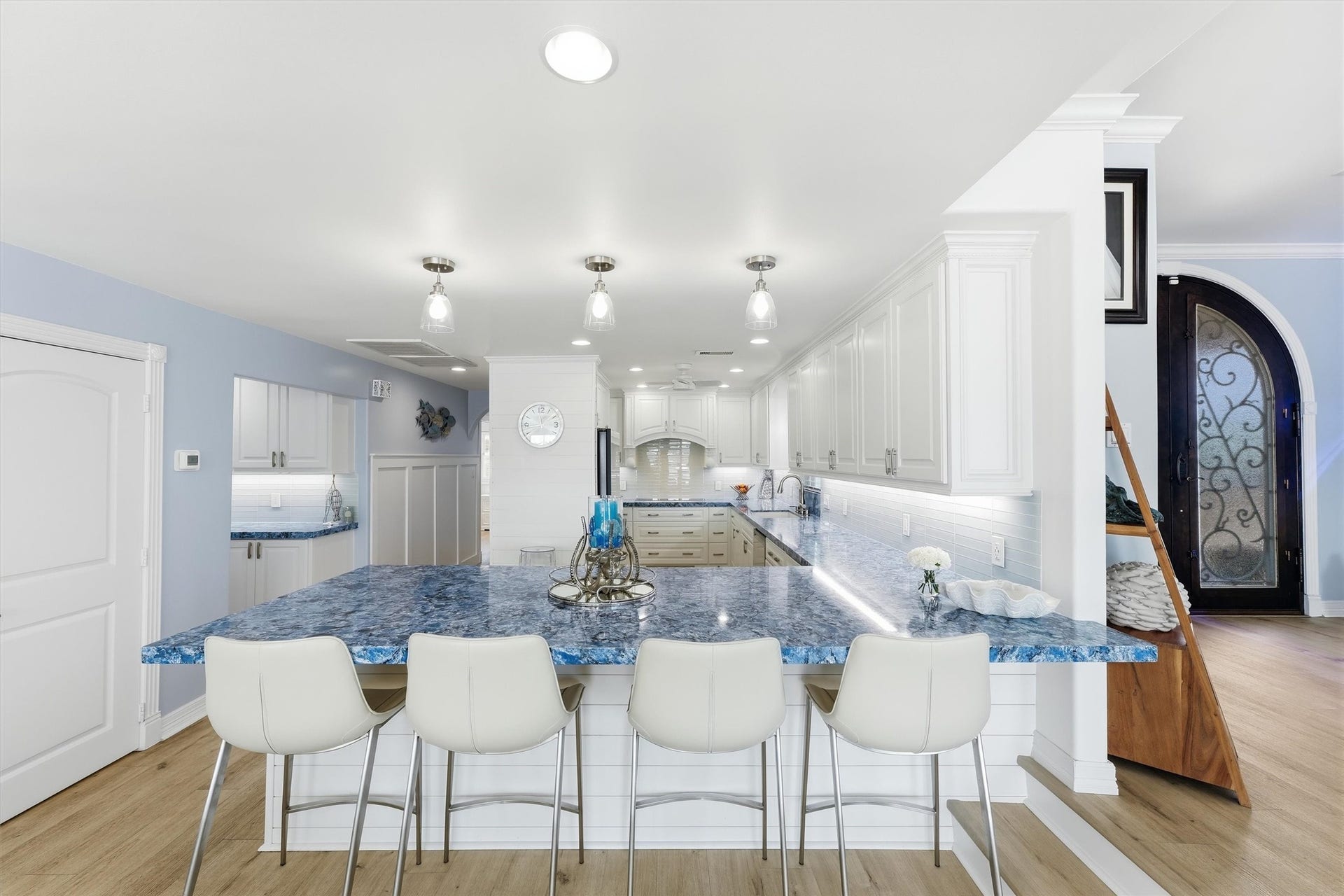 Expansive kitchen features generous counter space, abundant cabinetry, an oversized breakfast bar with seating, and an open layout designed for entertaining.