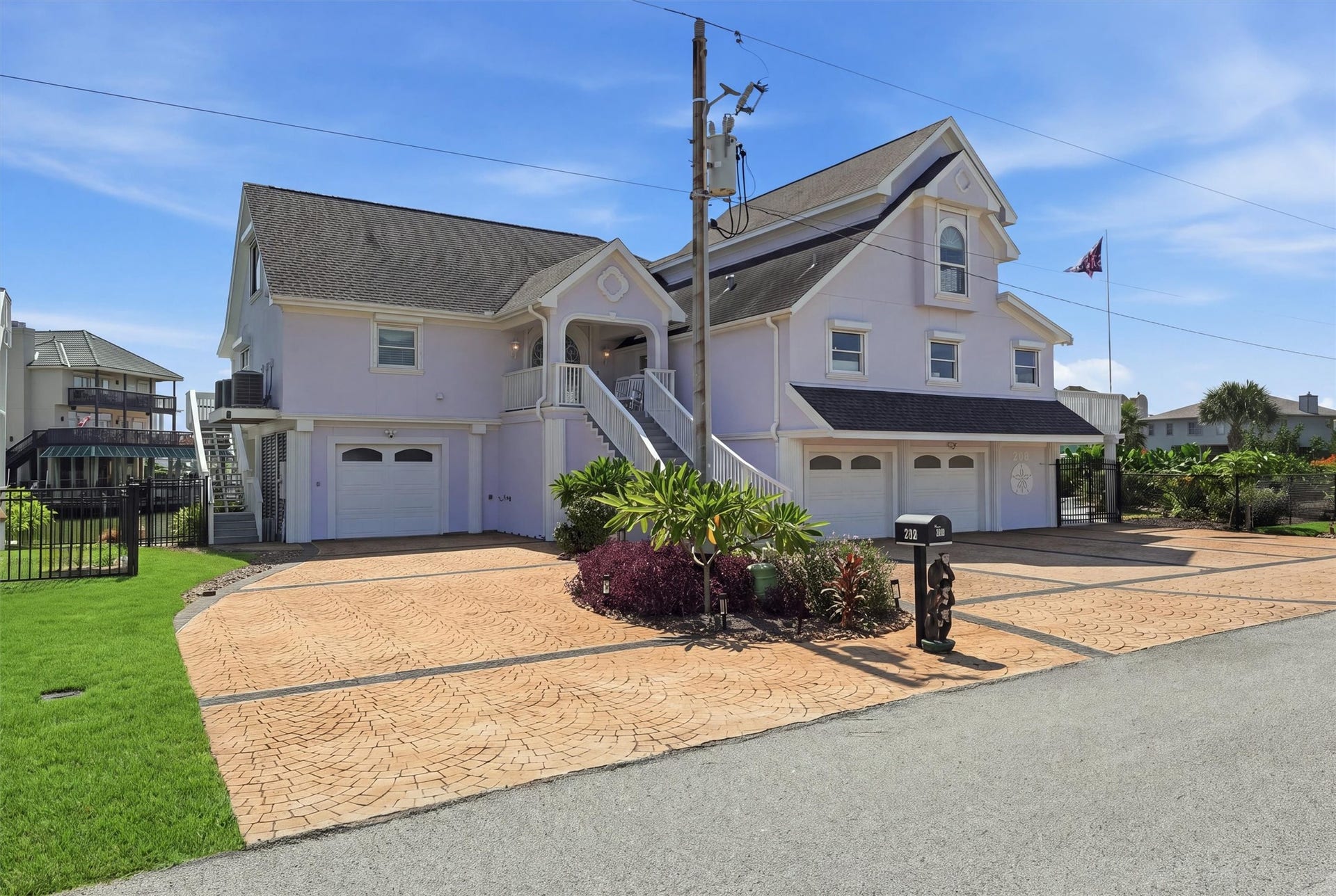 Wide exterior view highlights the generous 15,050 sq ft double lot, five-car garage, and plenty of additional outdoor parking space.