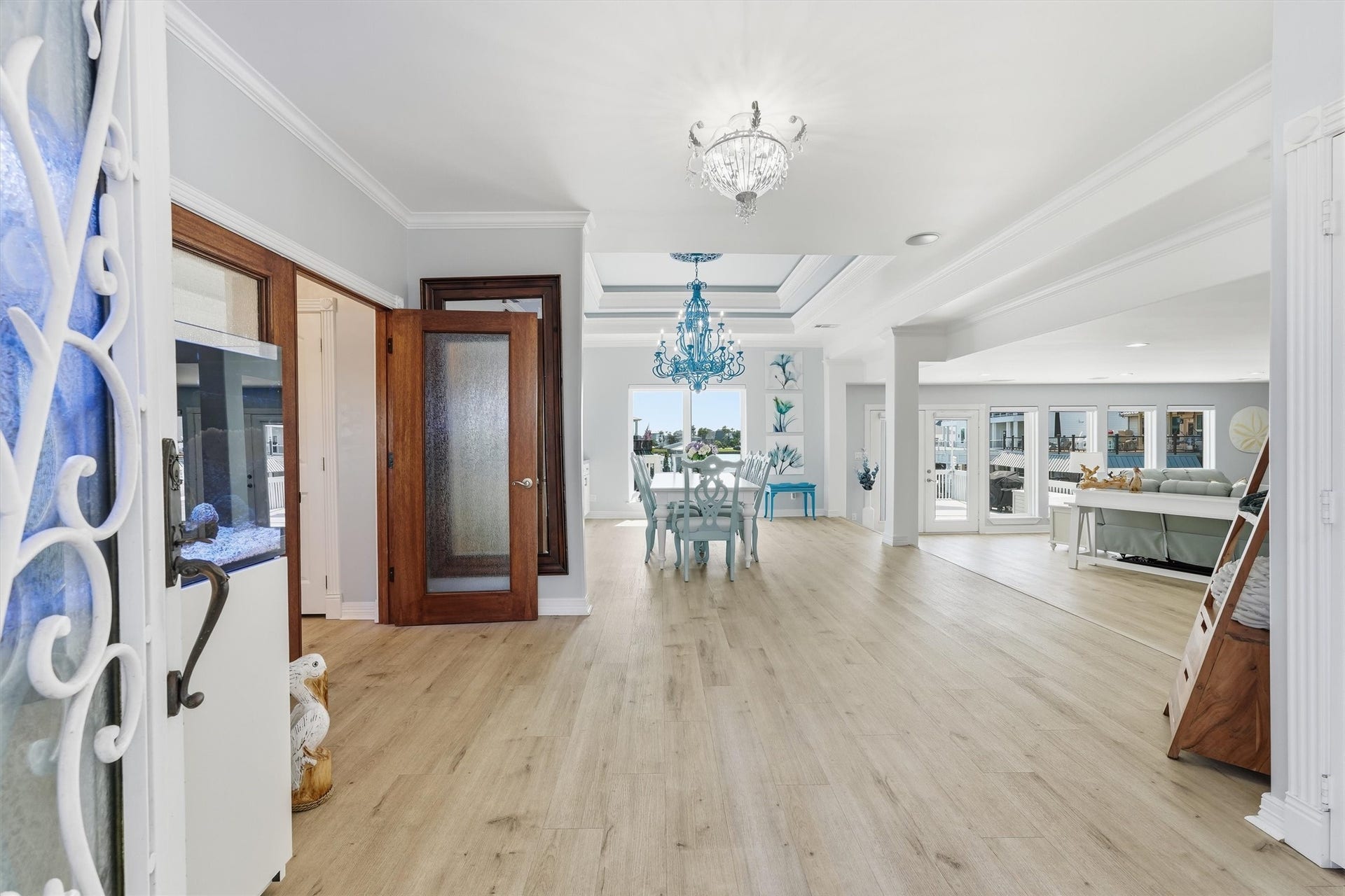 Step inside to a light-filled, open-concept layout designed to flow effortlessly toward the waterfront living spaces.