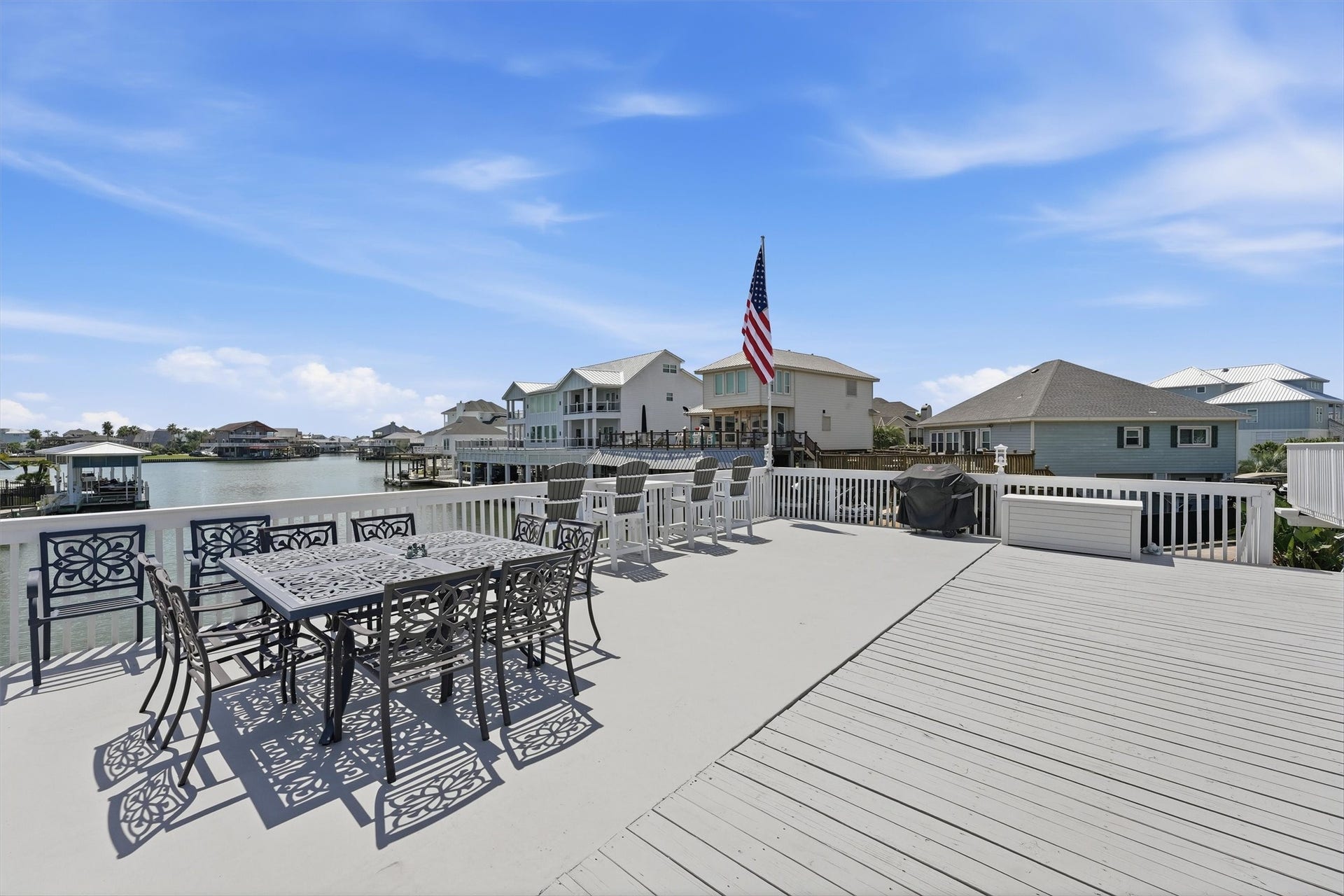 Expansive upper-level deck creates an exceptional outdoor entertaining space with wide canal views and plenty of room for dining and lounging.