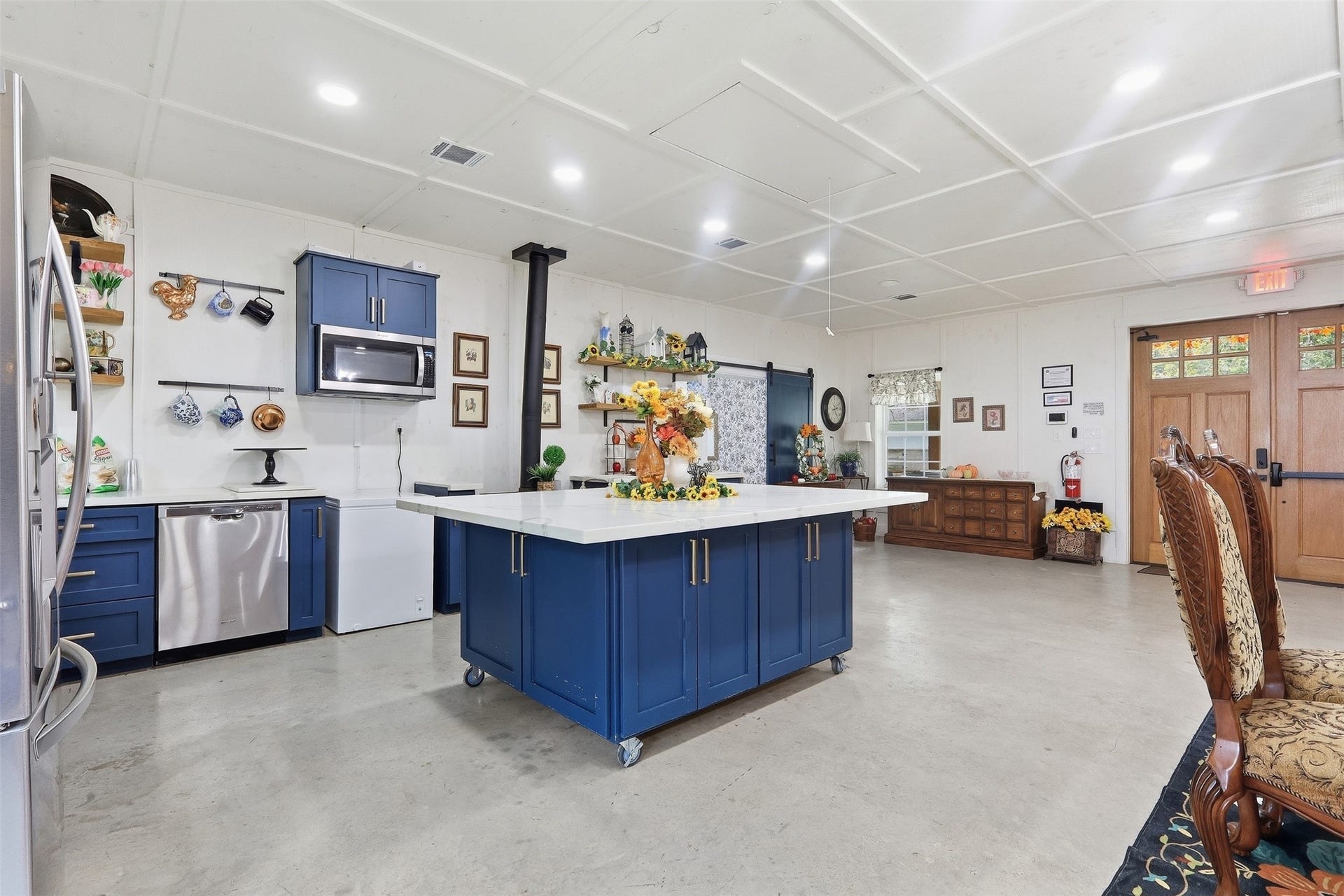 Full kitchen with wood burning stove, island on wheels, refrigerator and dishwasher