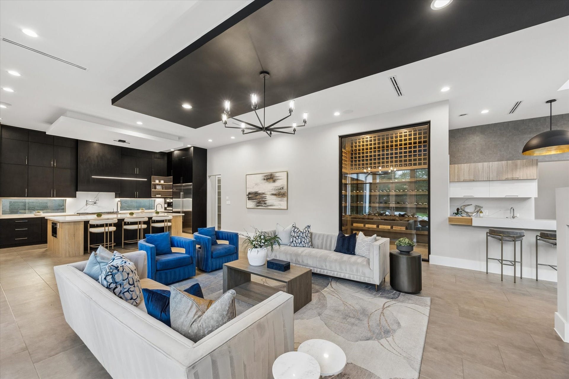 10943 Britoak Lane, Houston, TX 77079 Contemporary open-concept living space featuring a sleek kitchen with dark cabinetry, a custom wine display, and stylish finishes throughout.