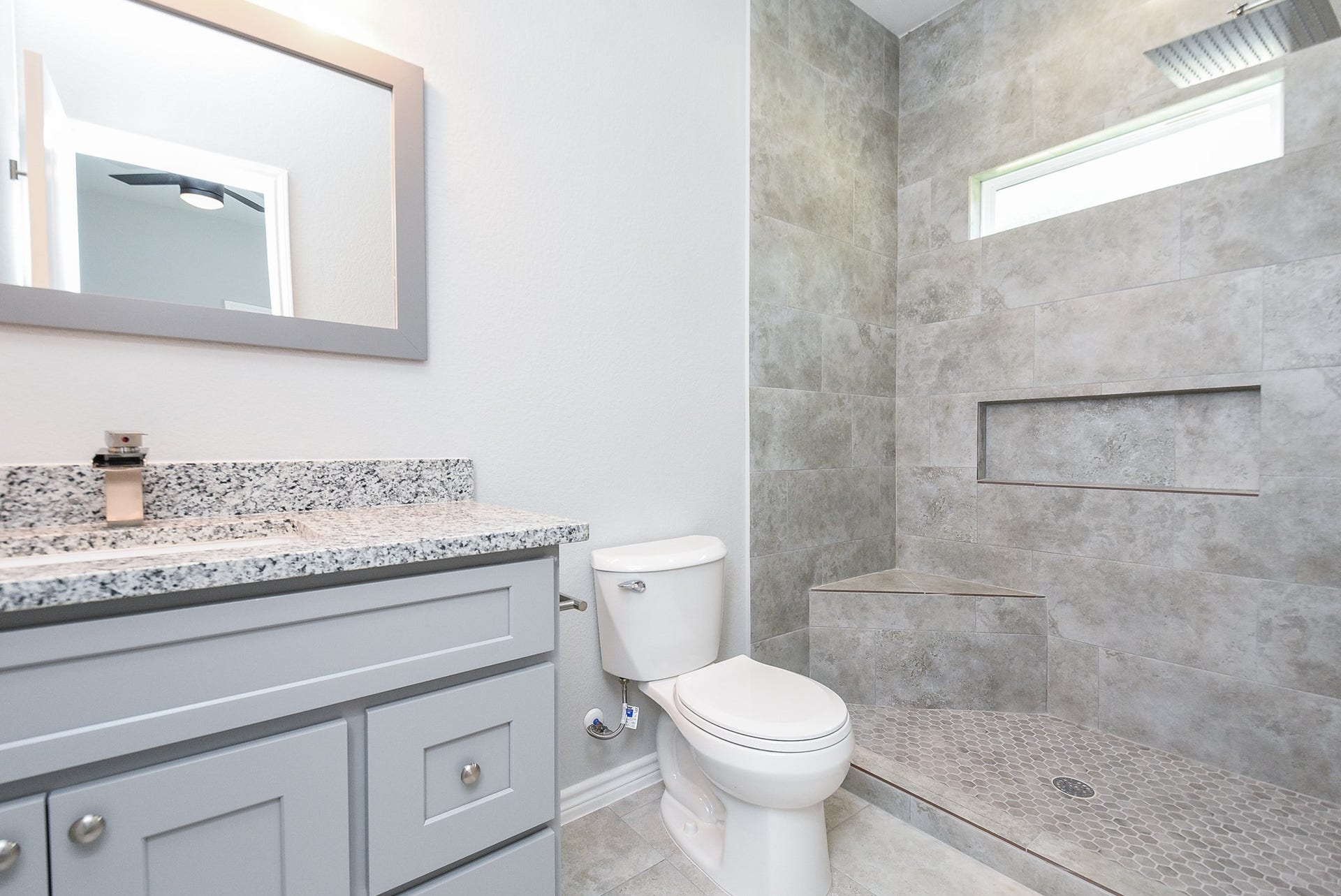 Beautiful tile in the shower. A glass shower door has been installed.