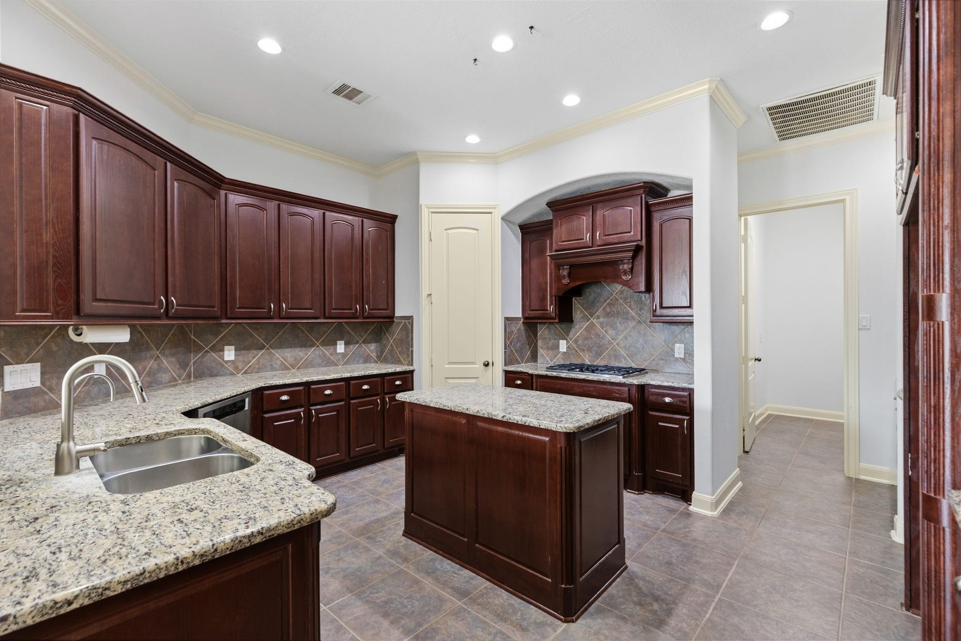 Nice big island kitchen with gas range!  Leads to dining area.