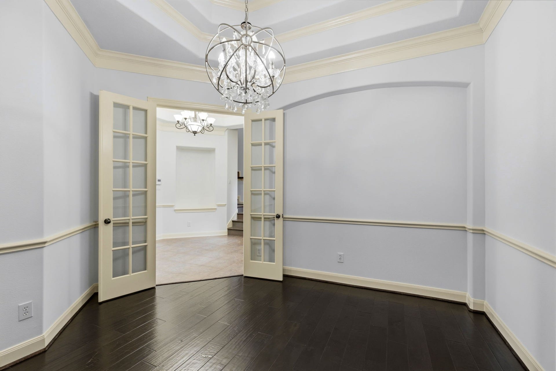 Dining room is off the foyer and also opens to the butler pantry in kitchen.  LOVE the chandelier and beautiful wood floors.  Notice the double tray ceiling with that beautiful crown molding.