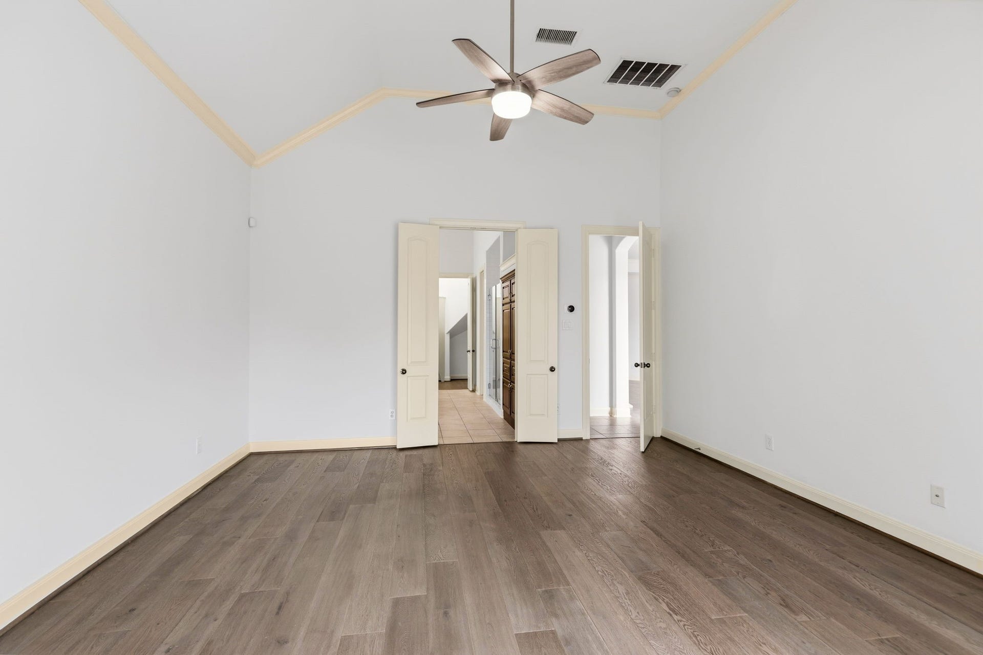 Anther view of the extra large primary retreat!  Looking from the sitting area into the en-suite bathroom. FRESH Interior paint throughout including all trim and doors!