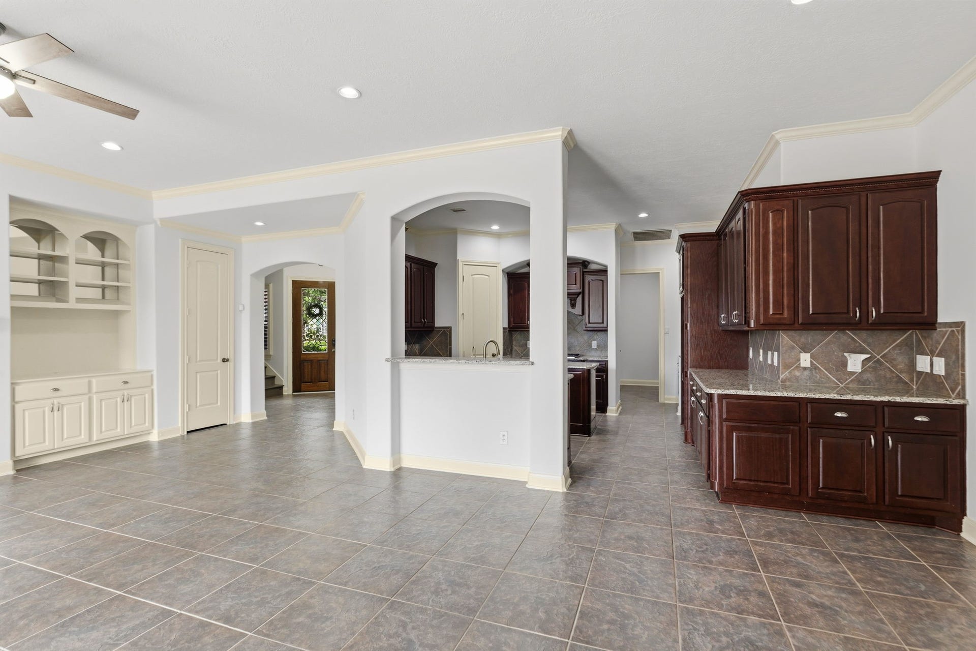 Looking from the family room into kitchen.  LOVE all those beautiful cabinets and built-ins in the living room.