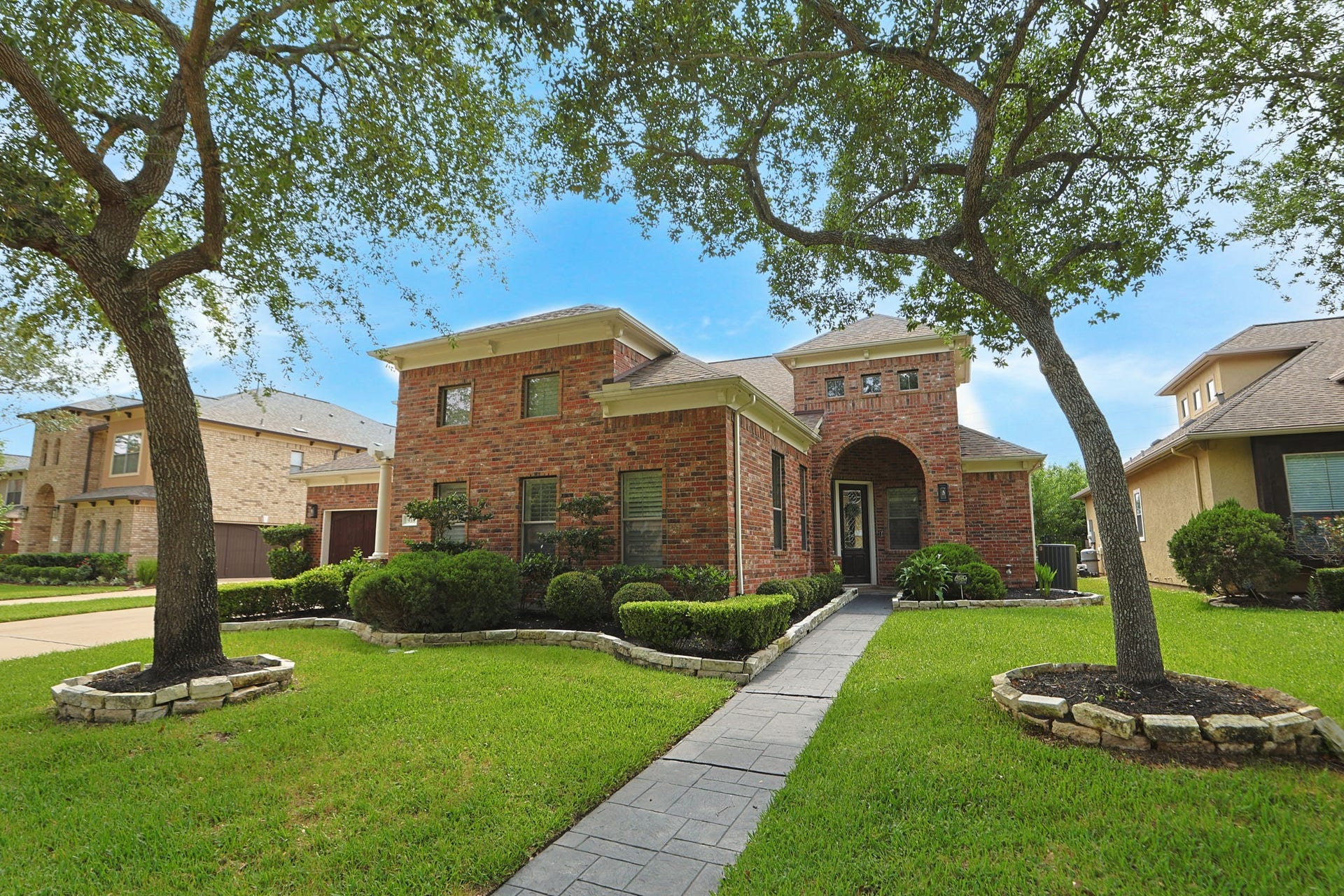 Beautiful home with sparkling pool and private basketball court in the exclusive enclave of The Estates of Oyster Creek.