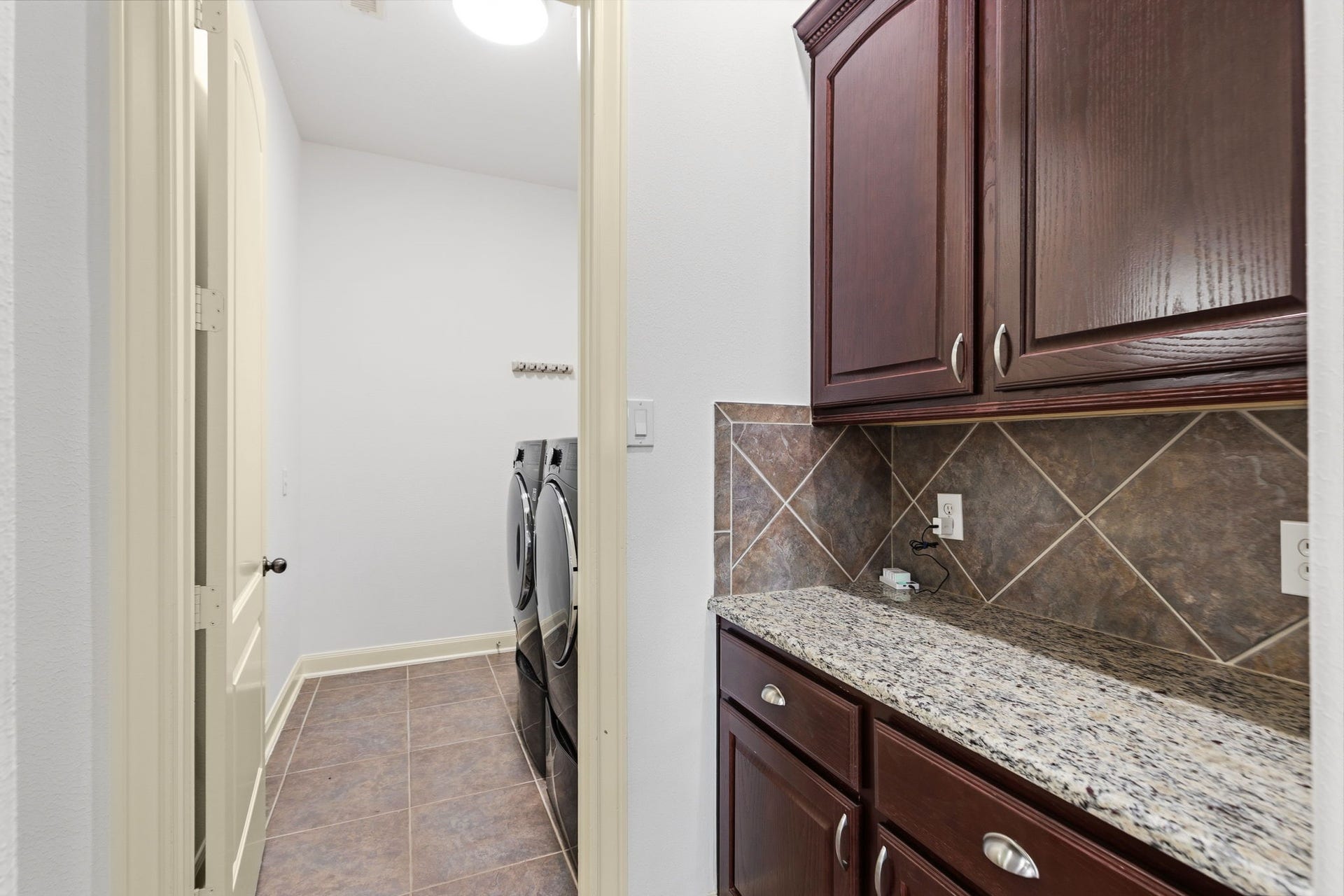 Butler pantry leading to dining on left and laundry in front.