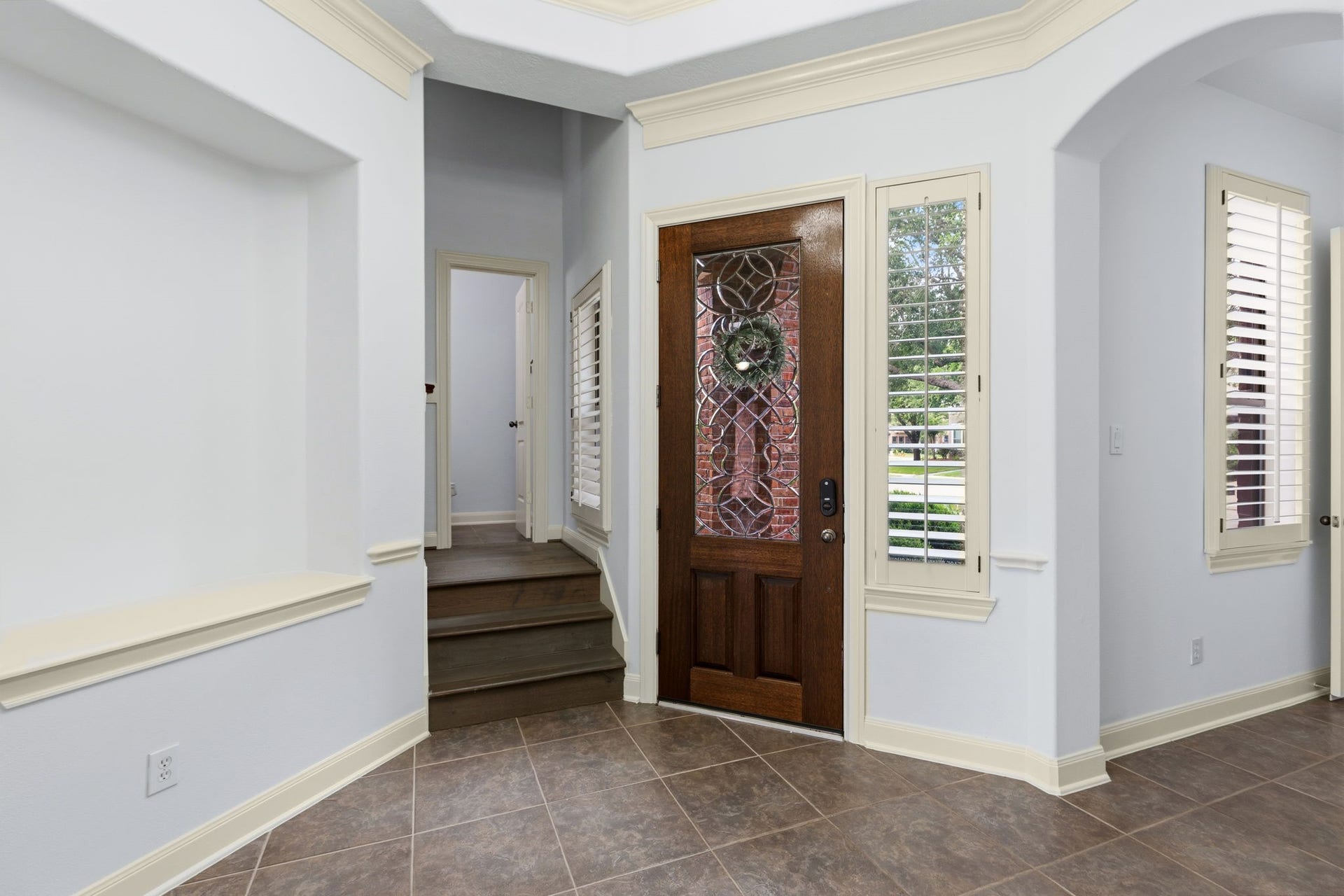 Another view of the entrance with stairs leading up to a big game room, balcony over looking the backyard and another large bed and bathroom.