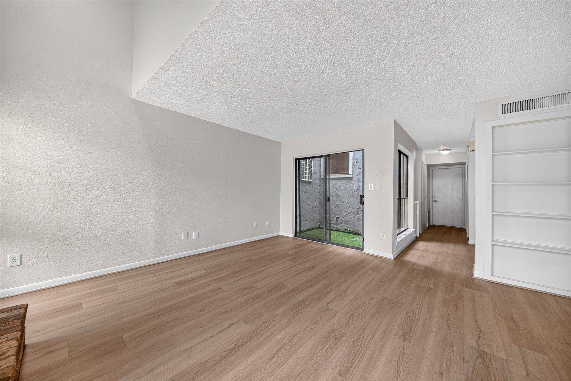Additional living room view highlighting sliding glass doors