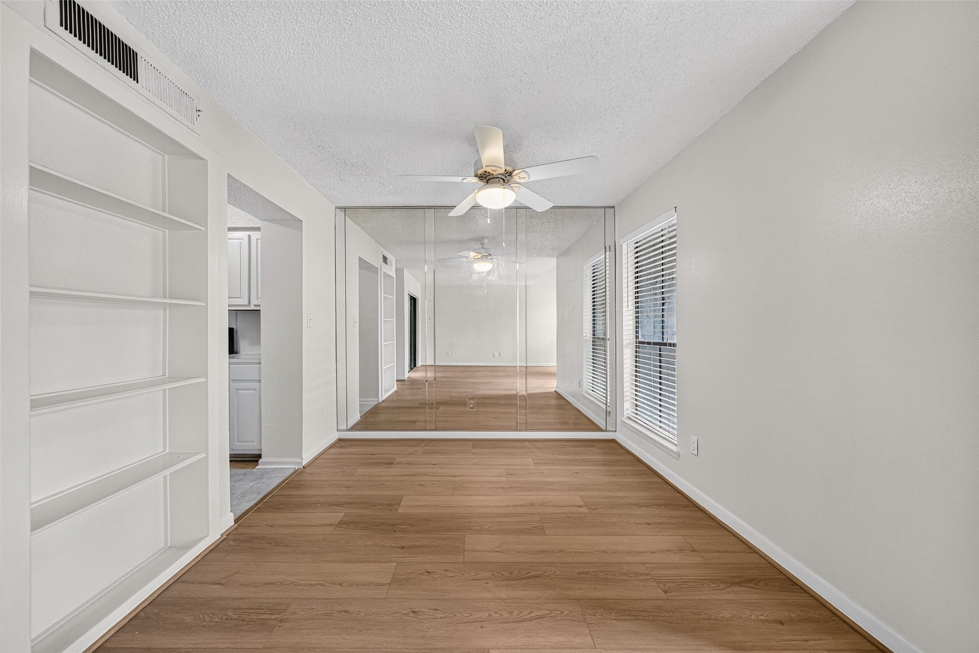 Another view of the dining area showcasing built-in display shelving and a spacious layout.
