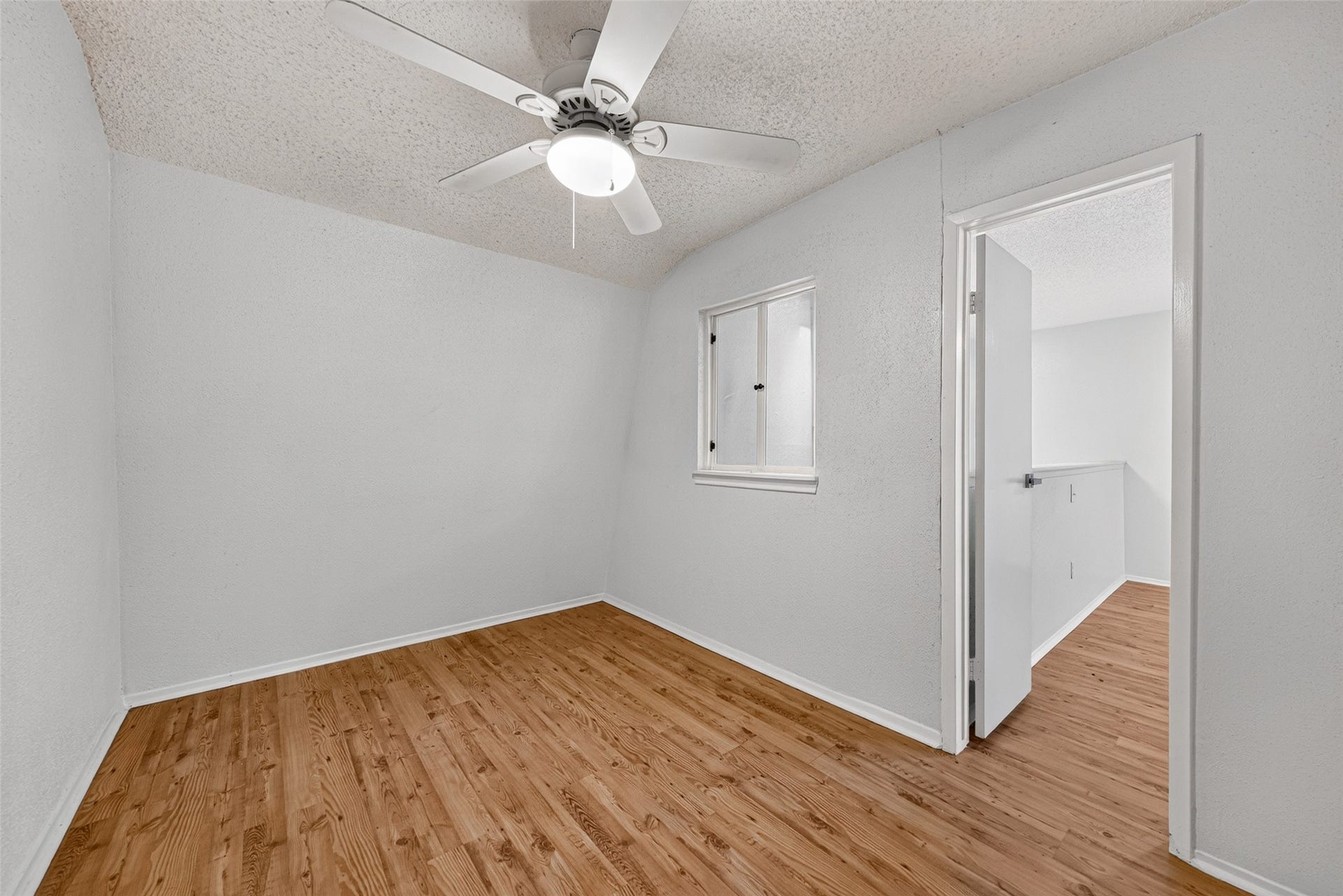 Bright flex room with ceiling fan and ample space for a study, hobby room, or home office.