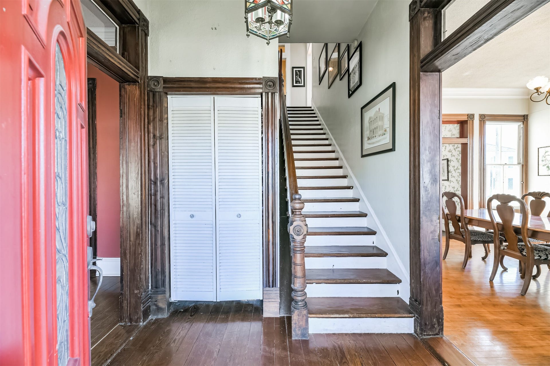 1927 Broadway Street, Galveston, TX 77550 From the covered front porch, step through the solid wood door with a decorative leaded glass insert and take a step back in time into this foyer with the original hardwood floors, a stained glass light fixture, and the staircase straight ahead.
