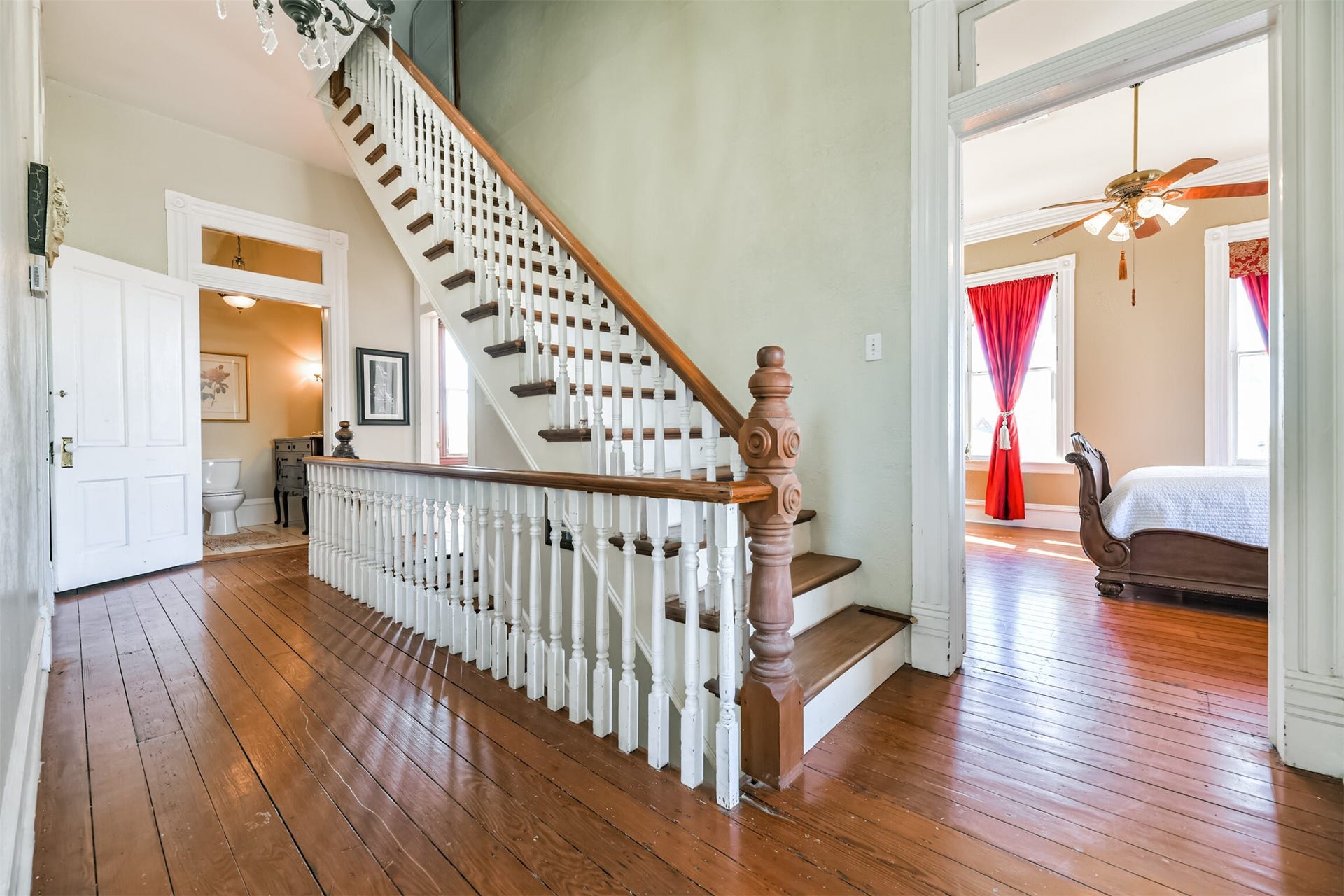 1927 Broadway Street, Galveston, TX 77550 The original staircase with wood treads, white balusters, and ornately carved newel posts leads up from the foyer to this second-floor landing that hosts long leaf pine floors along with three bedrooms and two bathrooms.