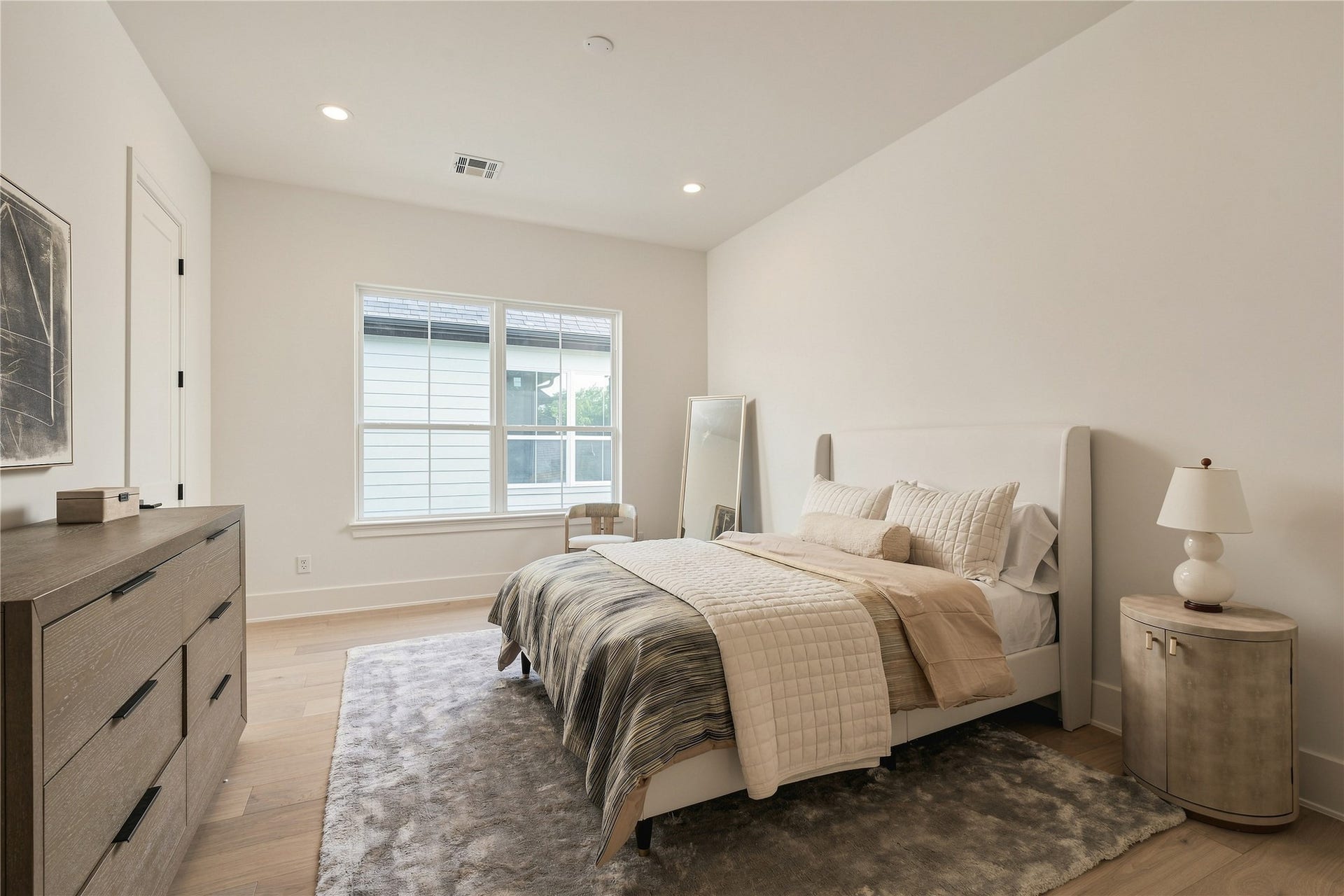 2107 McKean Drive, Houston, TX 77080 A spacious secondary bedroom offers generous proportions and excellent natural light, with ample room for a king-size bed and additional seating.